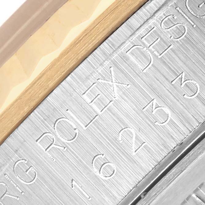 This image shows the engraved side of the case and the bezel edge of a Rolex Datejust 16233 Men's Steel and Gold (two tone) Beige Dial 16233 Men's Steel and Gold (two tone) Beige Dial watch.