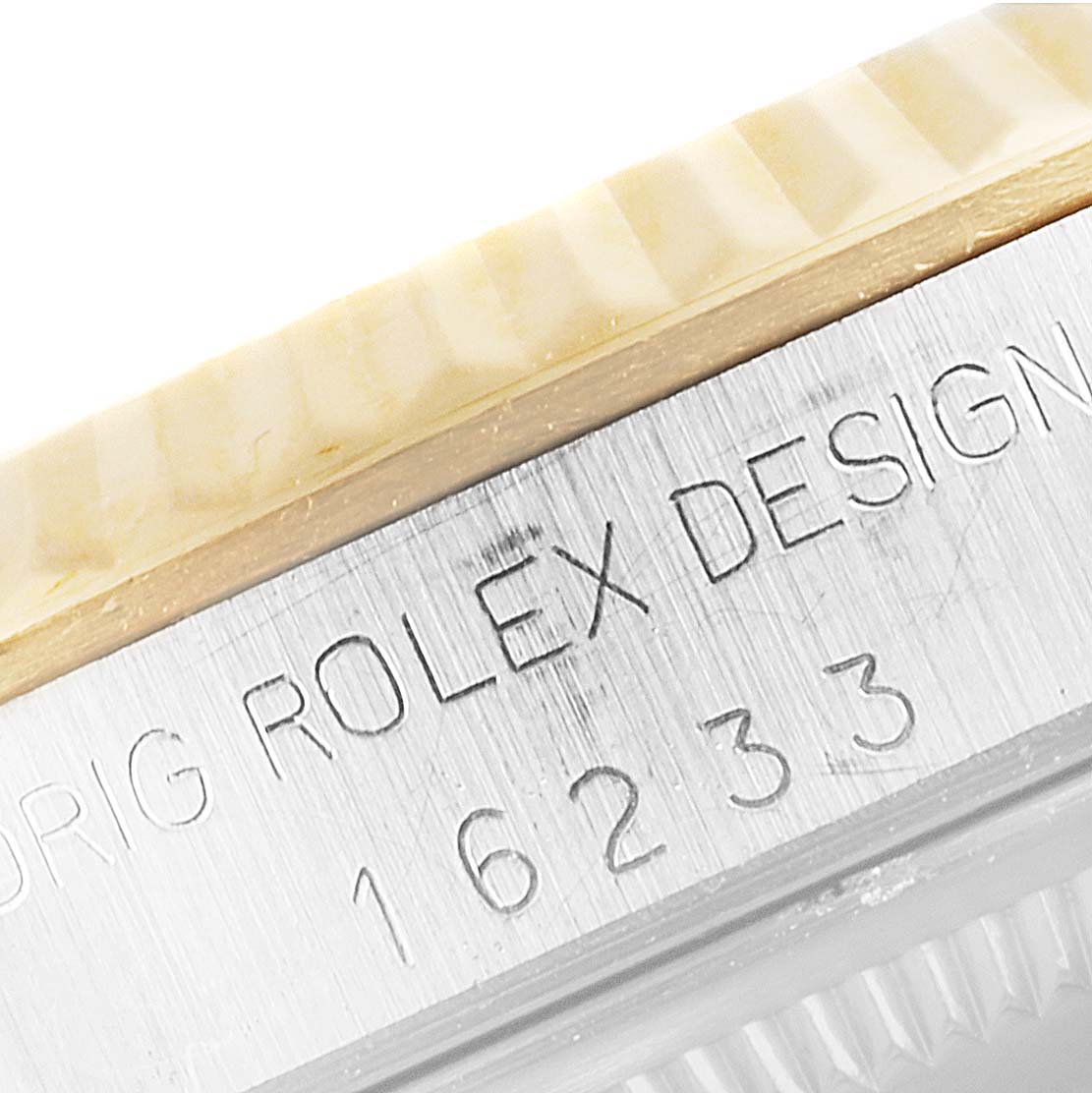 The image shows a close-up of the bezel and case side of a Rolex Datejust 16233 Men's Steel and Gold (two tone) Champagne Dial 16233 Men's Steel and Gold (two tone) Champagne Dial model with the engraving "ORIG ROLEX DESIGN 16233."