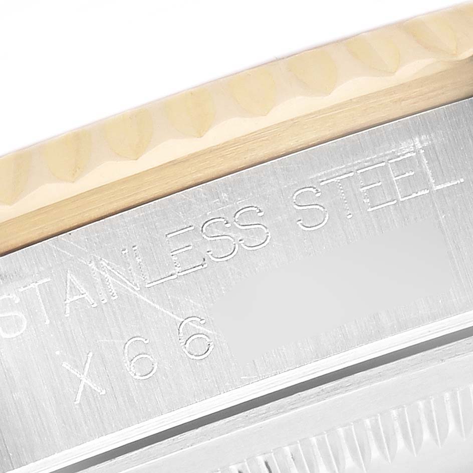 The image shows a close-up of the engraved bezel and case side of a Rolex Datejust 16233 Men's Steel and Gold (two tone) White Dial 16233 Men's Steel and Gold (two tone) White Dial watch.