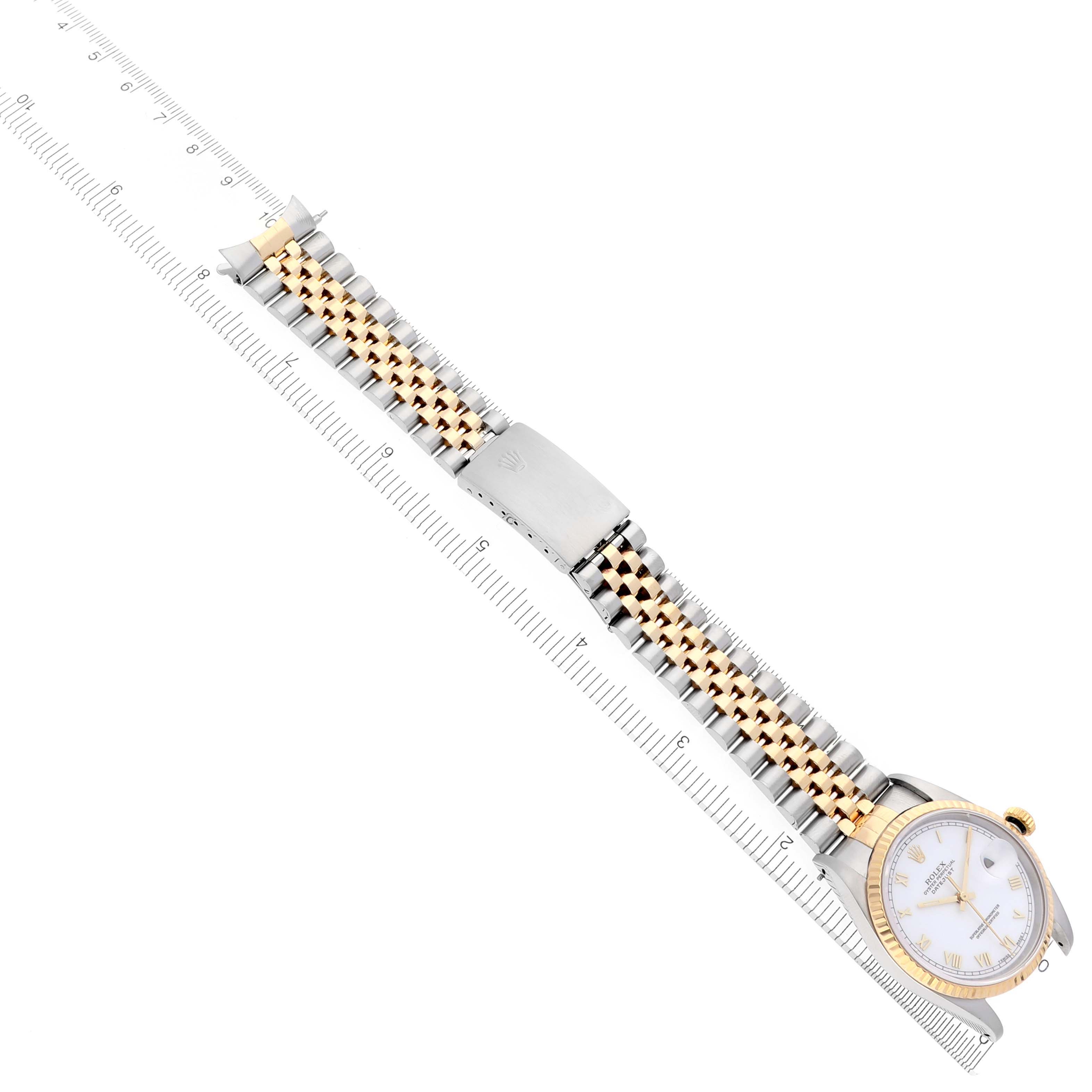 The image shows a Rolex Datejust 16233 Men's Steel and Gold (two tone) White Dial 16233 Men's Steel and Gold (two tone) White Dial watch laid flat, highlighting the dial, Jubilee bracelet, and clasp next to a ruler.