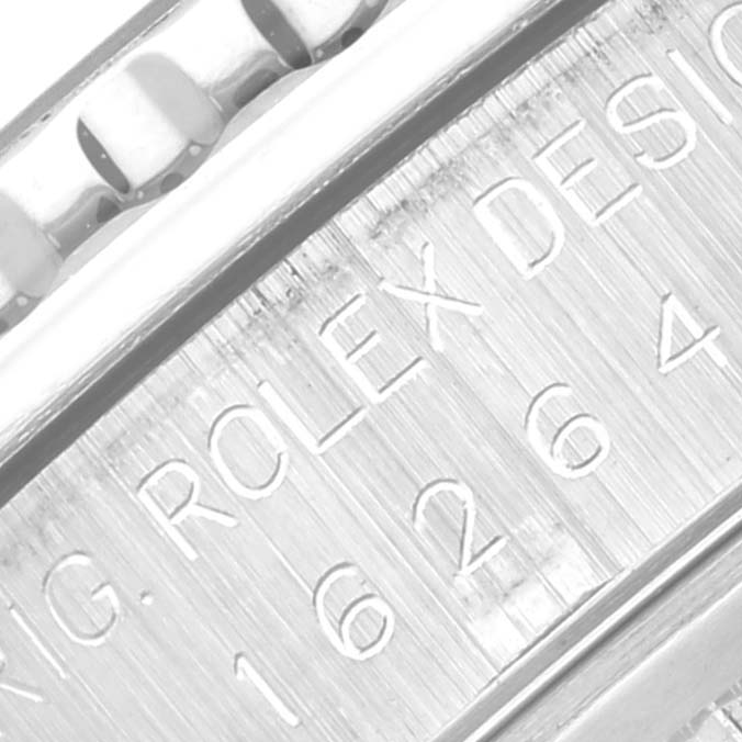 The image shows a close-up of the engraving on the Rolex Turn-o-Graph 16264 Men
s Stainless Steel Black Dial 16264 Men
s Stainless Steel Black Dial model, focusing on the watch
s serial number.