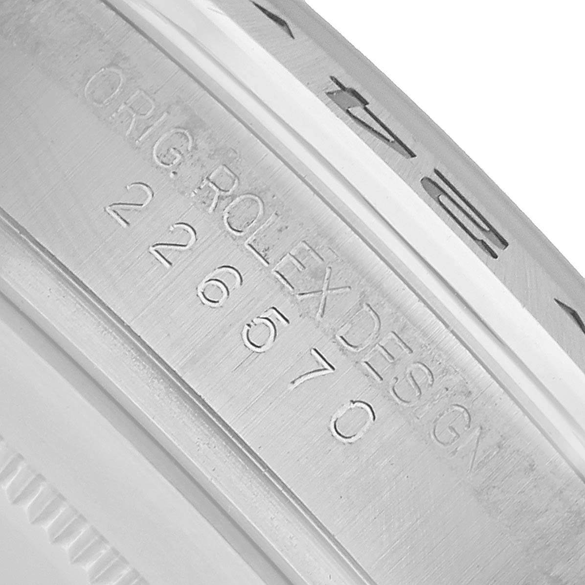 The image shows a close-up of the inner bezel engraving on a Rolex Explorer 226570 Men's Stainless Steel White Dial, featuring the model number and "ORIG ROLEX DESIGN."