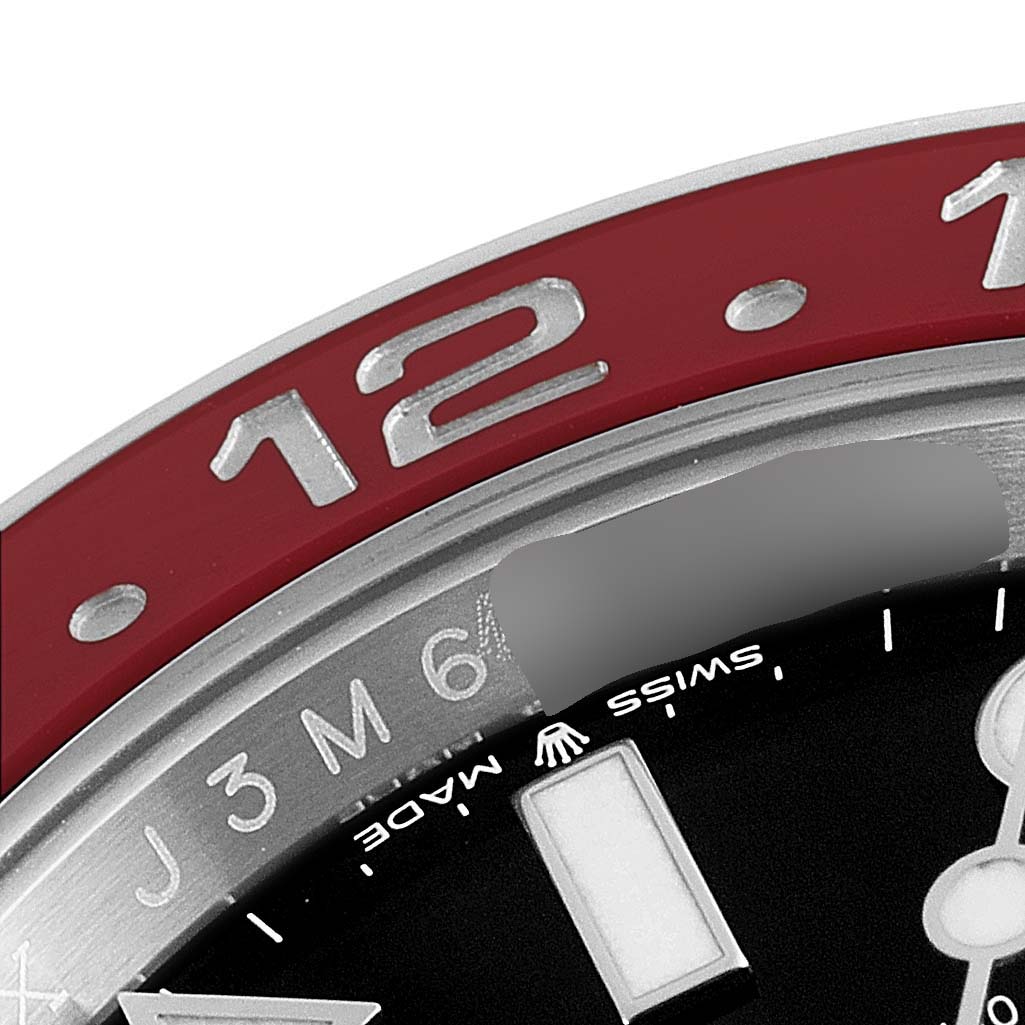 Close-up of the Rolex GMT-Master 126710 Men
s Stainless Steel Black Dial 126710 Men
s Stainless Steel Black Dial showing part of the bezel, dial, and inscriptions "SWISS MADE" and "12".