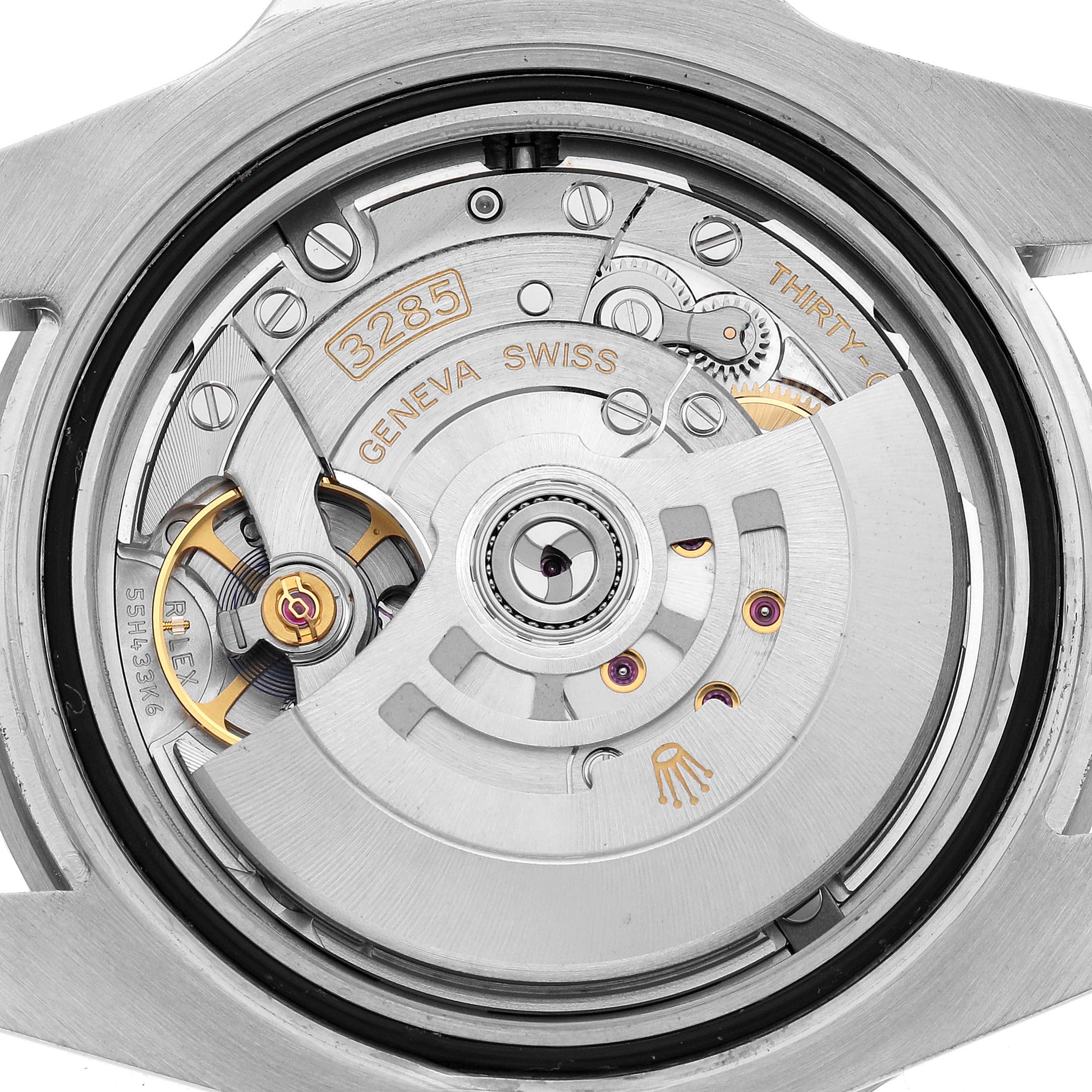 The image shows a close-up of the movement inside a Rolex GMT-Master 126710BLNR Men's Stainless Steel Black Dial watch, focusing on the rotor and gears.