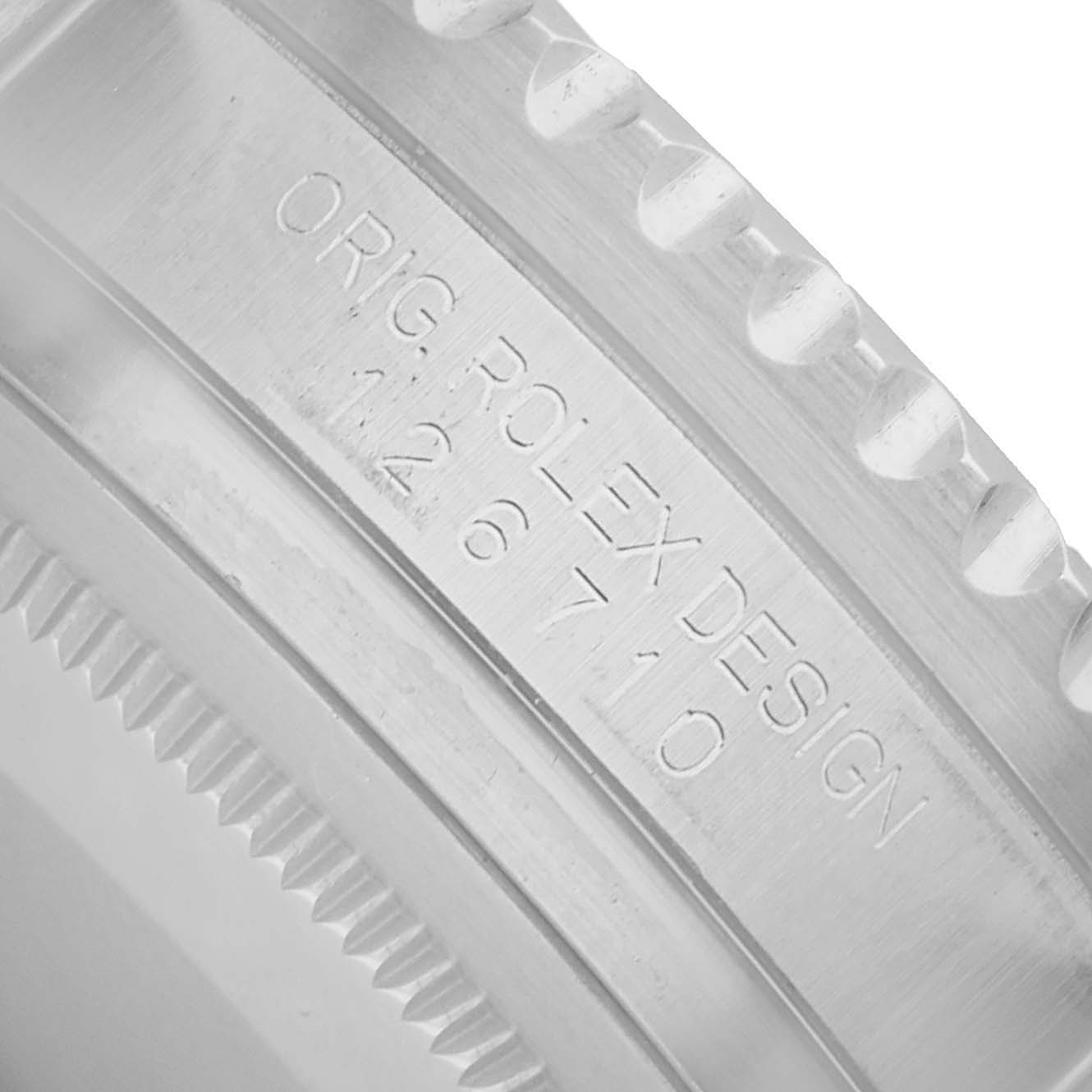 The image shows a close-up of the side of a Rolex GMT-Master 126710BLNR Men's Stainless Steel Black Dial's case, focusing on the engraving details.