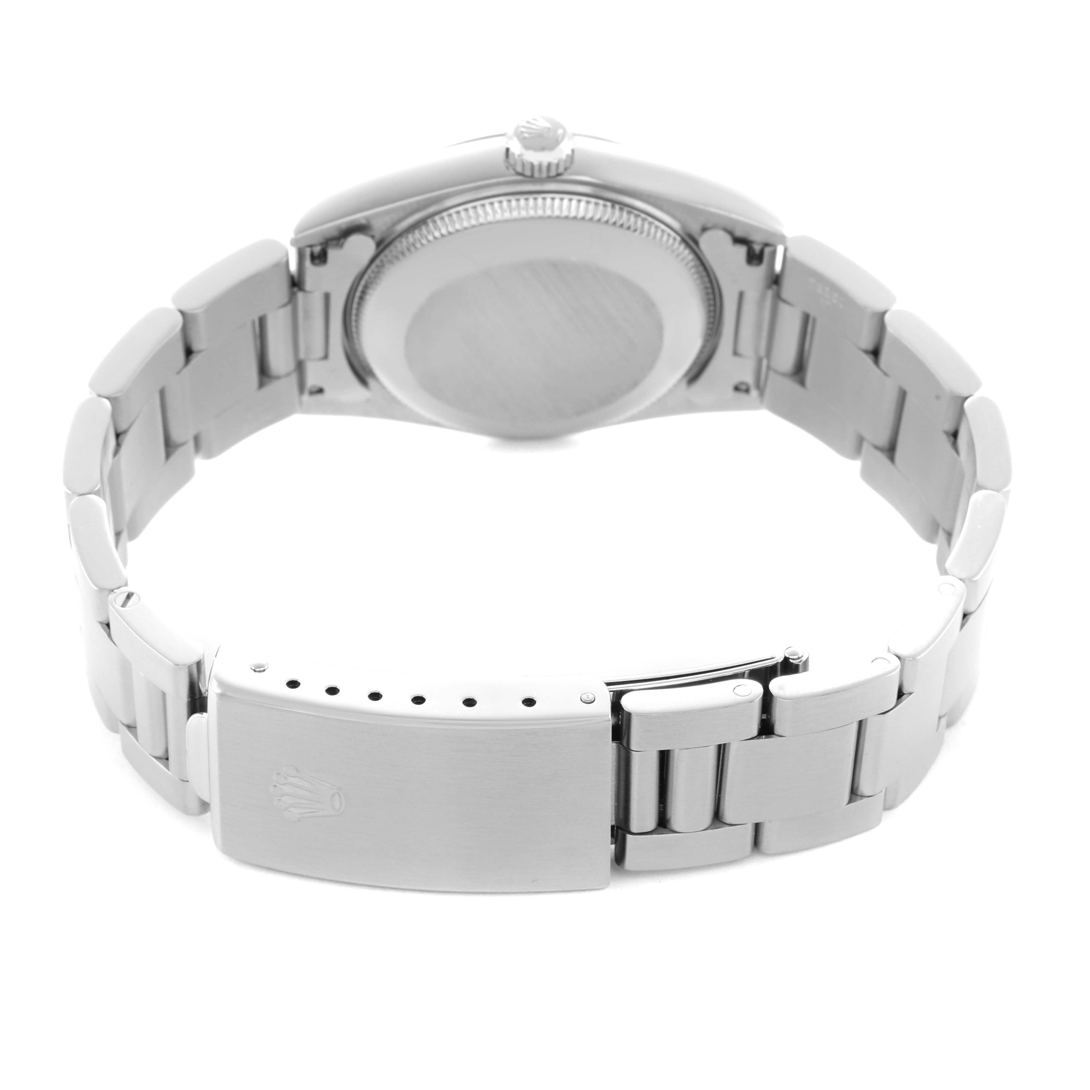 The Rolex Oyster Perpetual 77080 Women's Stainless Steel Blue Dial watch is viewed from the back, showing the case back and the adjustable clasp on the bracelet.