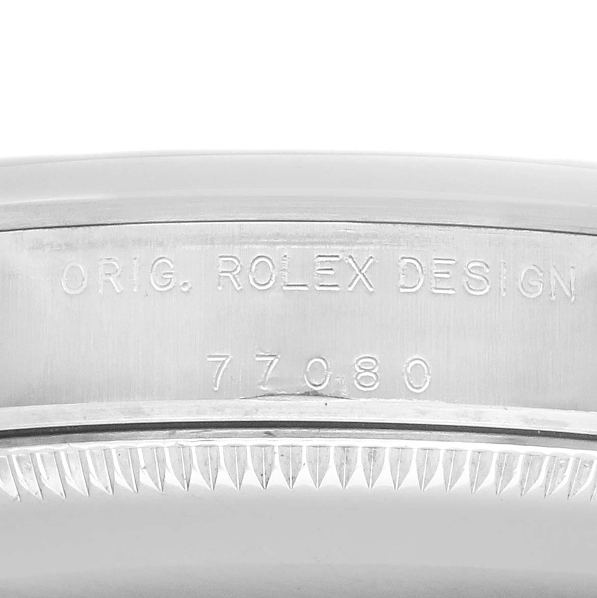 The image shows the side engraving on the case of a Rolex Oyster Perpetual 77080 Women's Stainless Steel Blue Dial watch, displaying the original design inscription and model number.