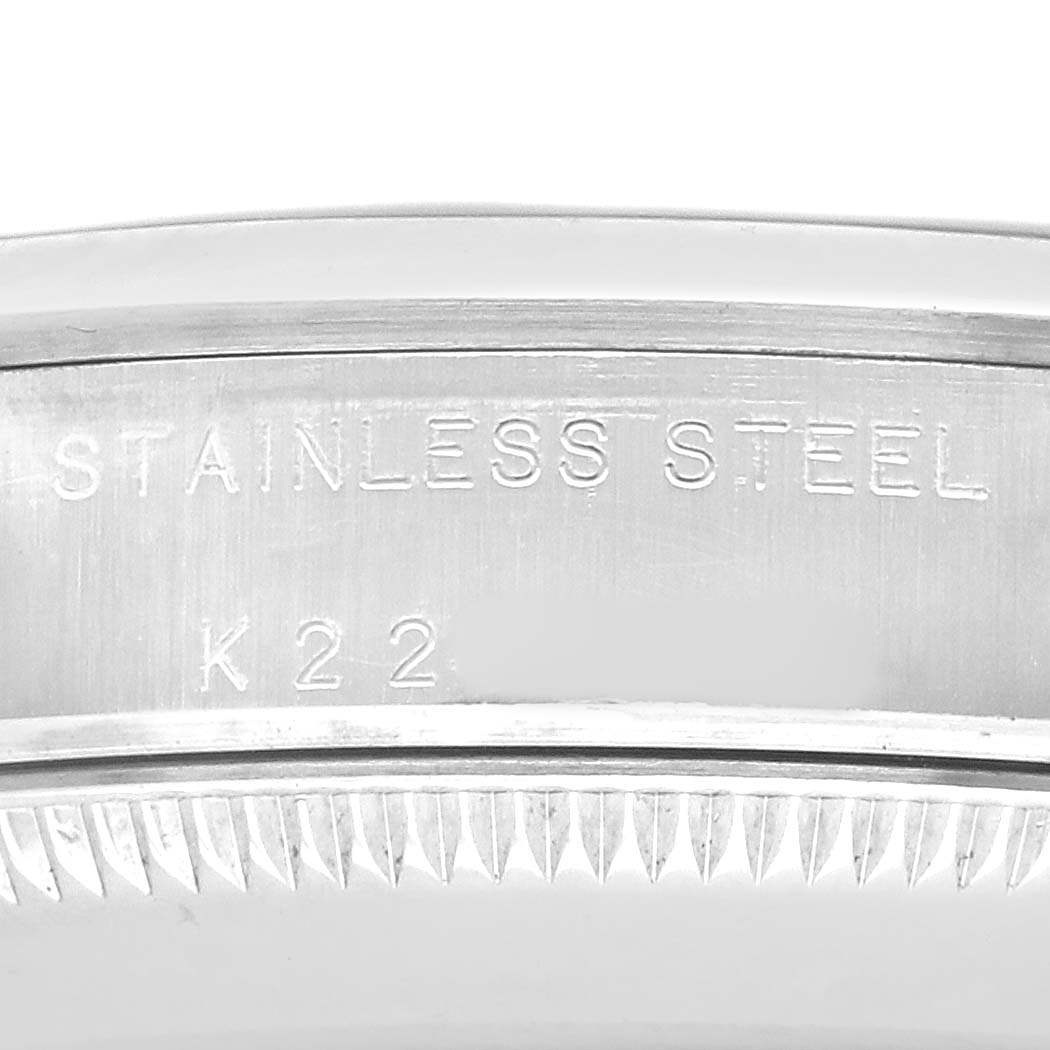 The image shows the side of a Rolex Oyster Perpetual 77080 Women's Stainless Steel Blue Dial watch case, highlighting the stainless steel engraving.