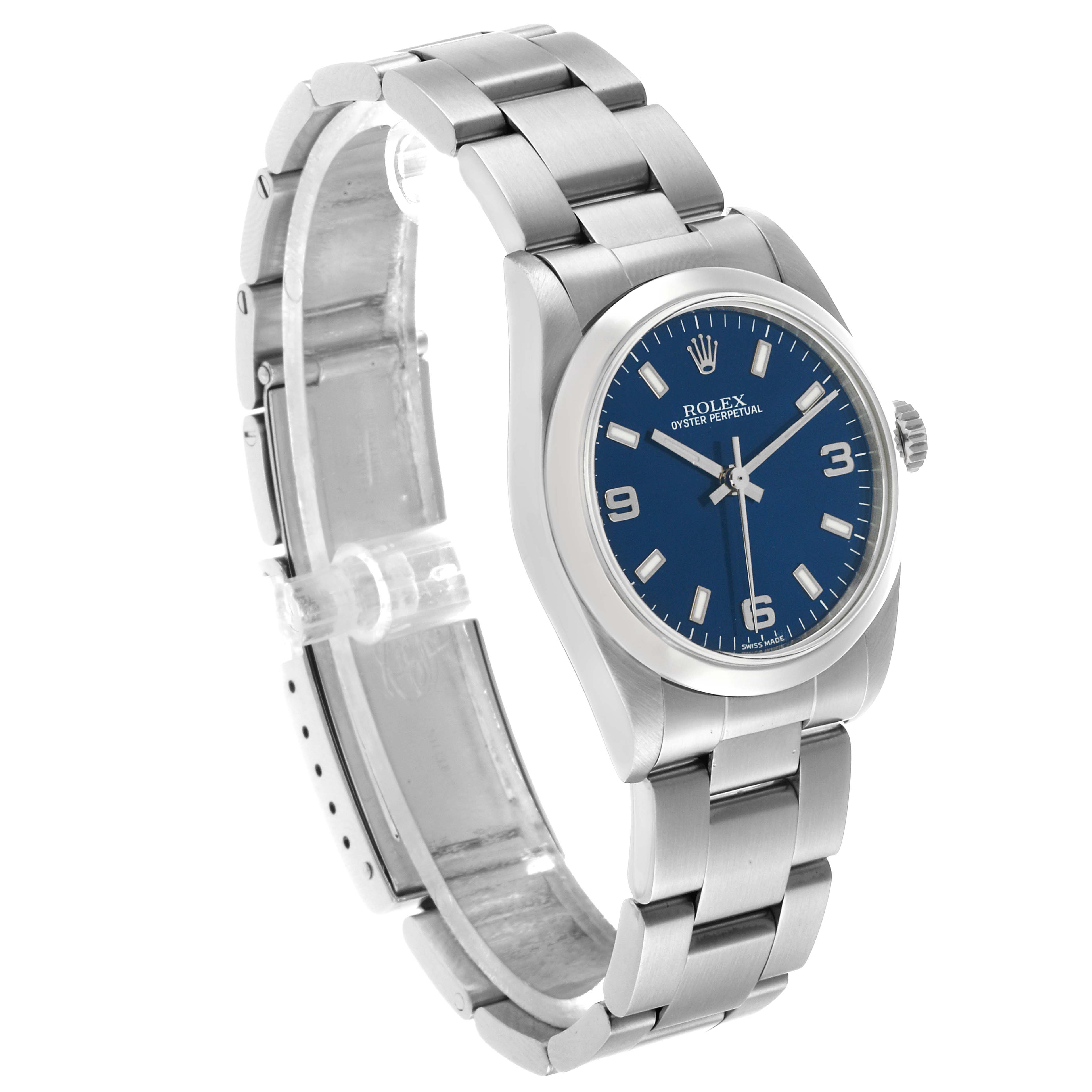 The Rolex Oyster Perpetual 77080 Women's Stainless Steel Blue Dial watch is shown at a three-quarter angle, highlighting the blue dial, bezel, case, and stainless steel bracelet.