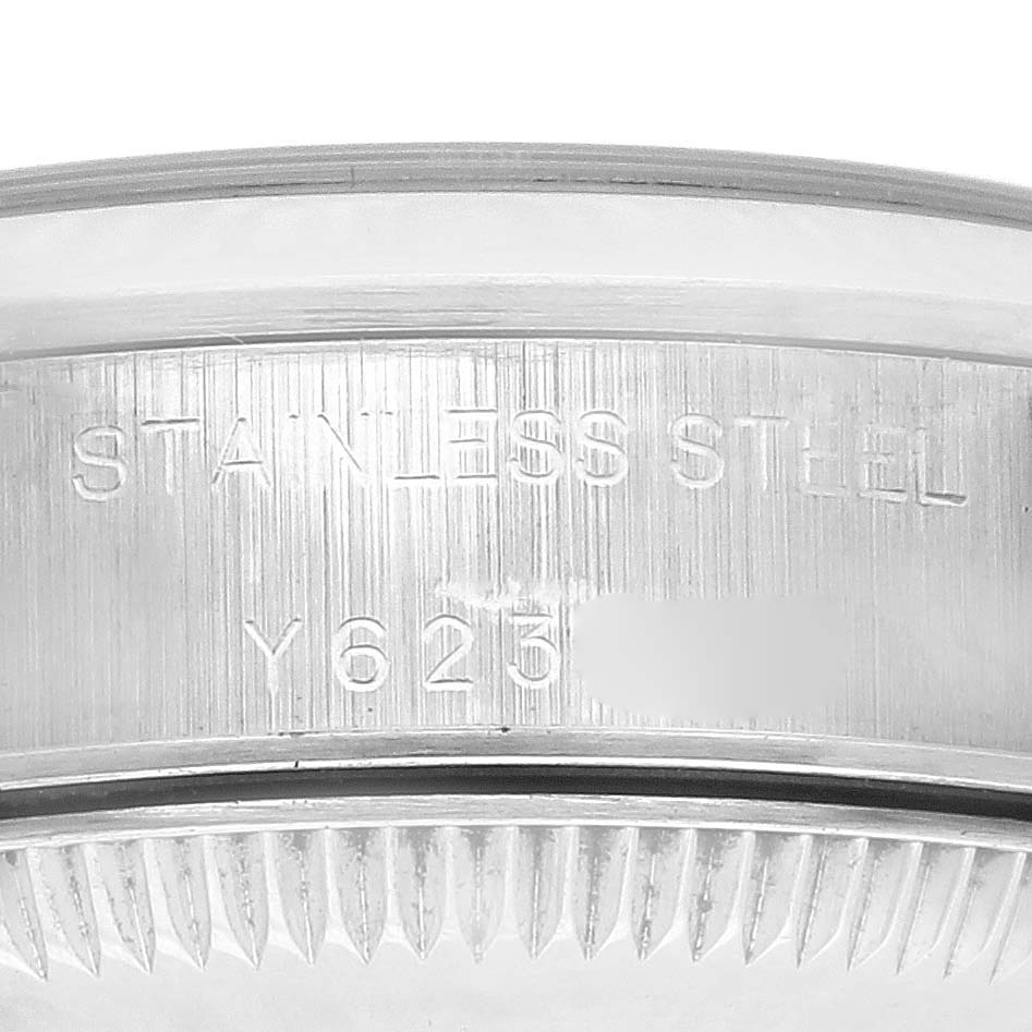 The image shows a close-up of the Rolex Oyster Perpetual 76080 Women's Stainless Steel Pink Dial 76080 Women's Stainless Steel Pink Dial's stainless steel bezel with engraved markings.