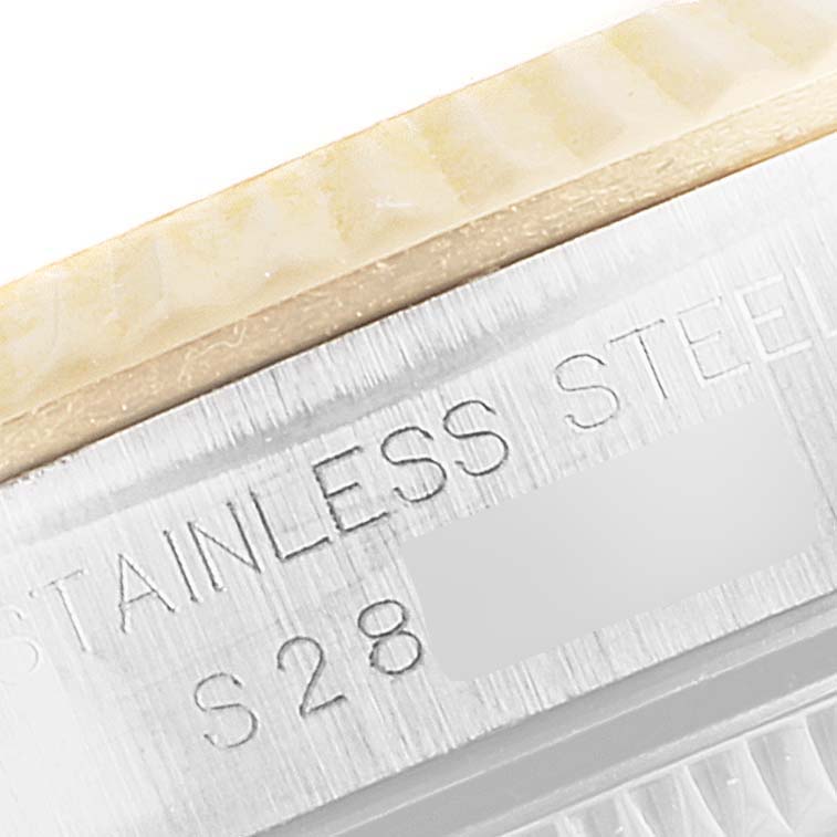 This close-up image shows part of the stainless steel case and engraving of a Rolex Oyster Perpetual 67193 Women's Steel and Gold (two tone) Champagne Dial 67193 Women's Steel and Gold (two tone) Champagne Dial watch.