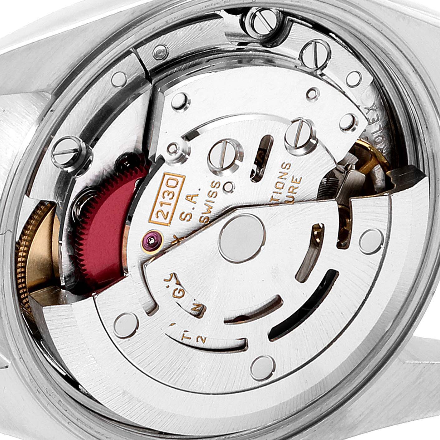 The image shows a close-up of the movement mechanism of a Rolex Oyster Perpetual 67183 Women
s Steel and Gold (two tone) White Dial 67183 Women
s Steel and Gold (two tone) White Dial watch, highlighting the intricate internal components.