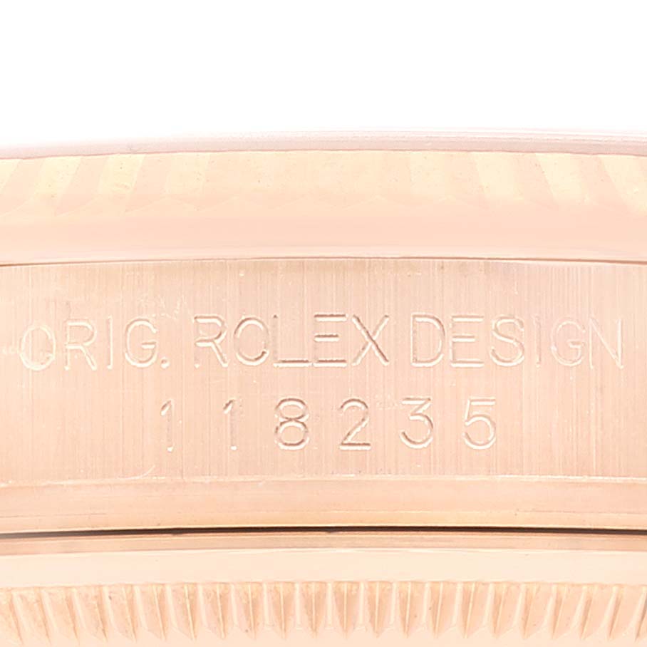 The image shows a close-up of the engraved side of a Rolex President 118235 Men's Rose Gold Black Dial 118235 Men's Rose Gold Black Dial watch, displaying the model number and design details.