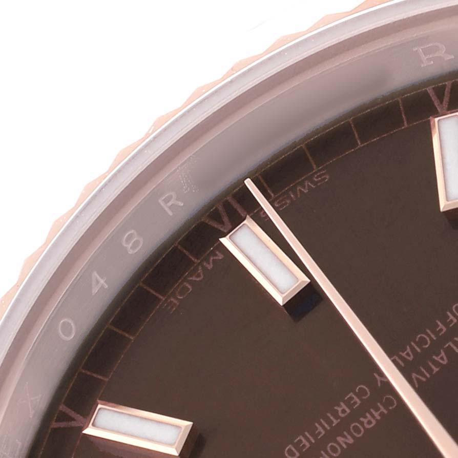 The image shows a close-up of the Rolex President 118135 Men's Rose Gold Brown Dial model watch dial, focusing on the Roman numeral hour markers and minute hand.