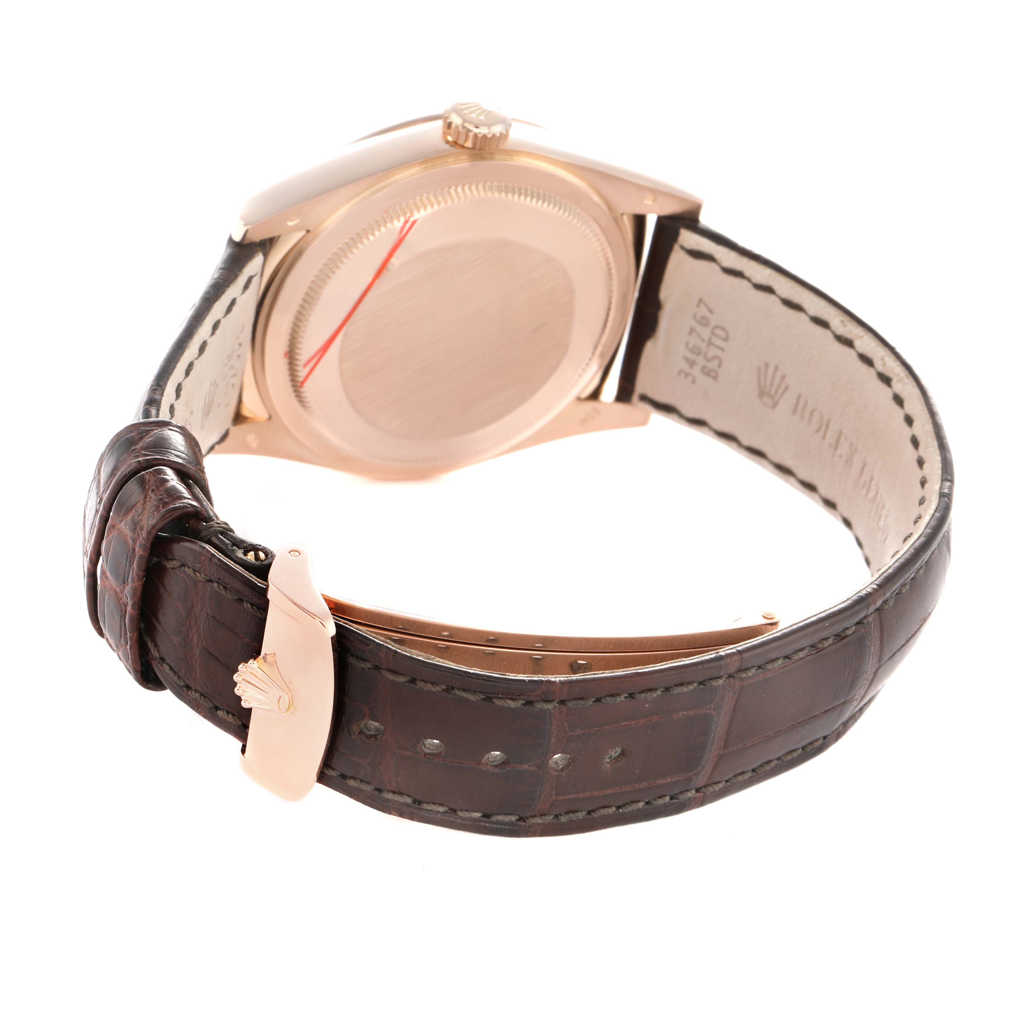 The Rolex President 118135 Men's Rose Gold Brown Dial watch is shown at an angled rear view, highlighting the case back, crown, and leather strap with a clasp.