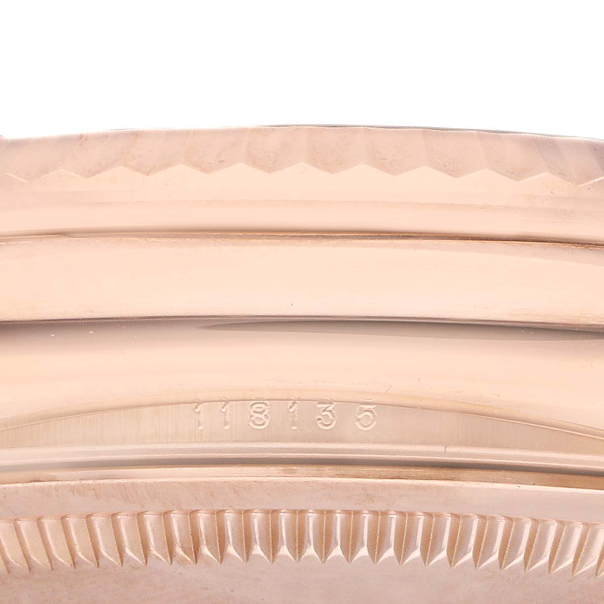The image shows a close-up of the side of a Rolex President 118135 Men's Rose Gold Brown Dial model, highlighting the bezel and case with engraved numbers.
