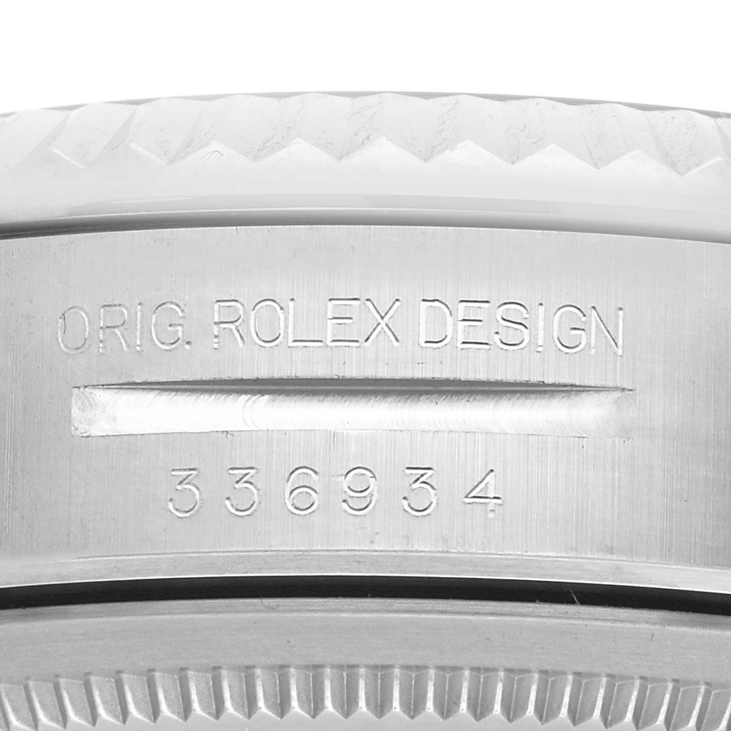 The image shows a close-up of the edge and engraved text on the bezel of a Rolex Sky-Dweller 336934 Men's Stainless Steel Blue Dial watch.