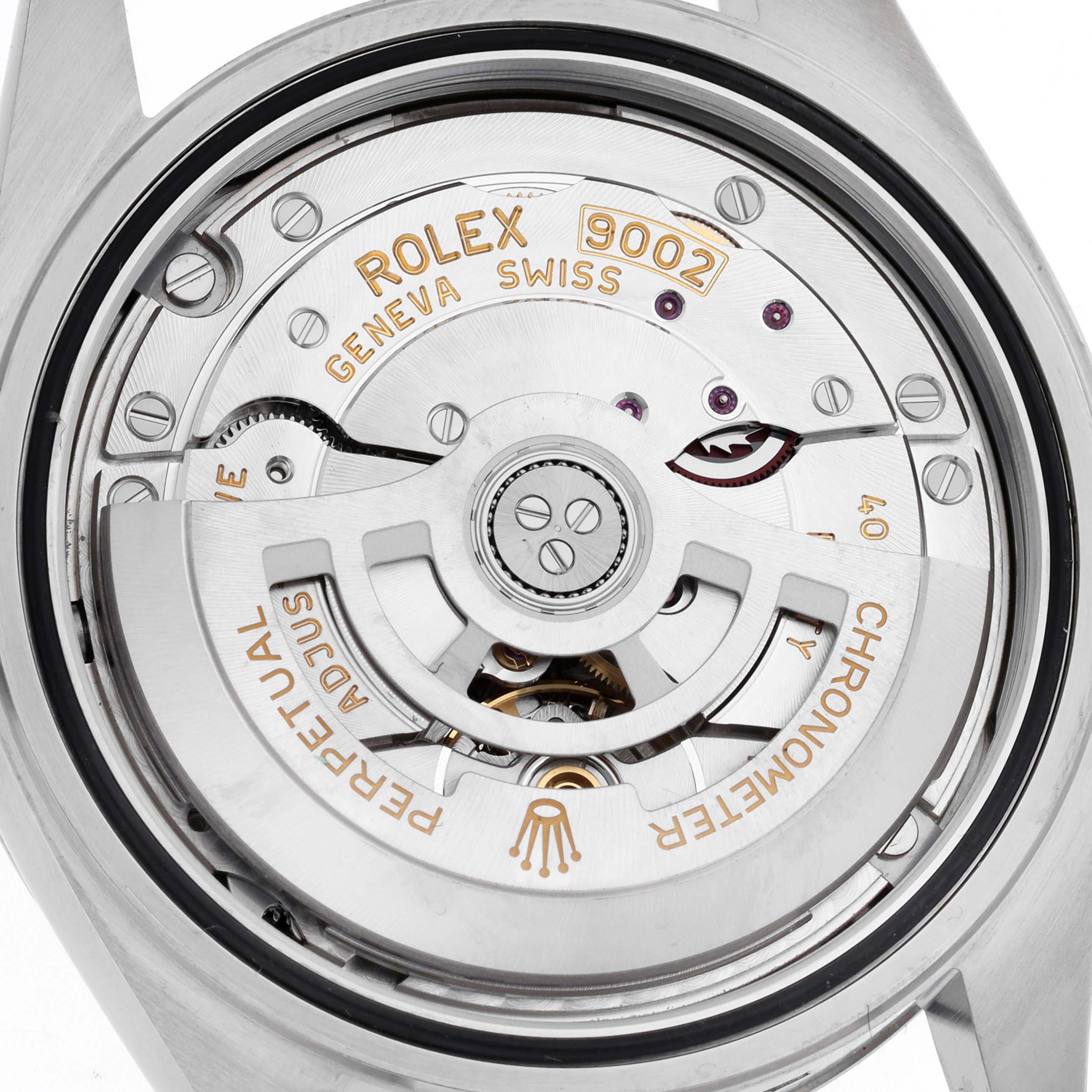 The image shows the exposed movement of a Rolex Sky-Dweller 336934 Men's Stainless Steel Blue Dial, highlighting the rotor and internal mechanics.