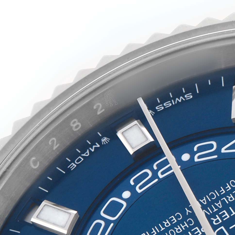 The image shows a close-up of the Rolex Sky-Dweller 336934 Men's Stainless Steel Blue Dial watch, focusing on the blue dial, markers, and part of the fluted bezel.