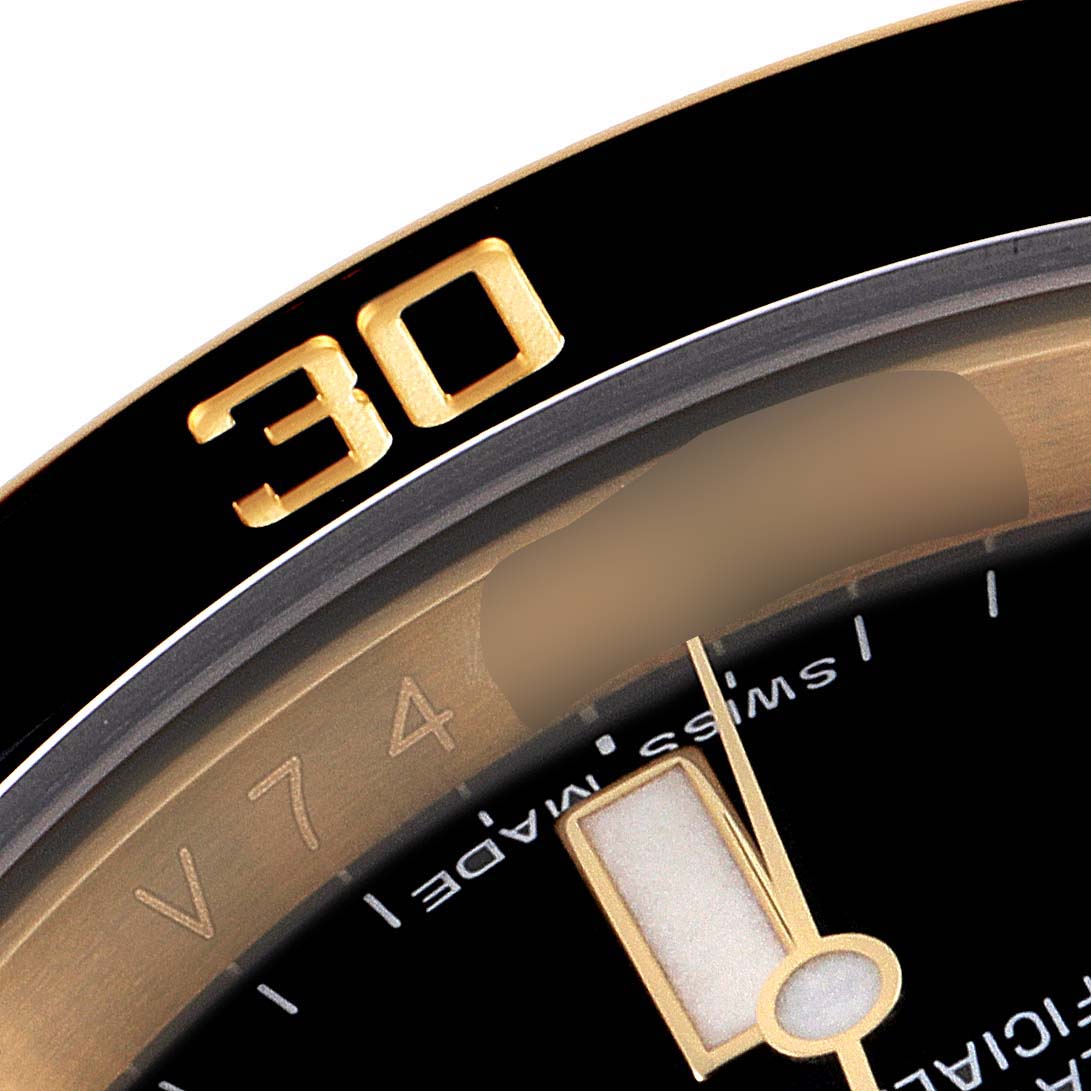The image shows a close-up of the bezel and partial dial of a Rolex Submariner 116618 Men
s Yellow Gold Black Dial 116618 Men
s Yellow Gold Black Dial watch, highlighting the number 30 and Swiss Made text.