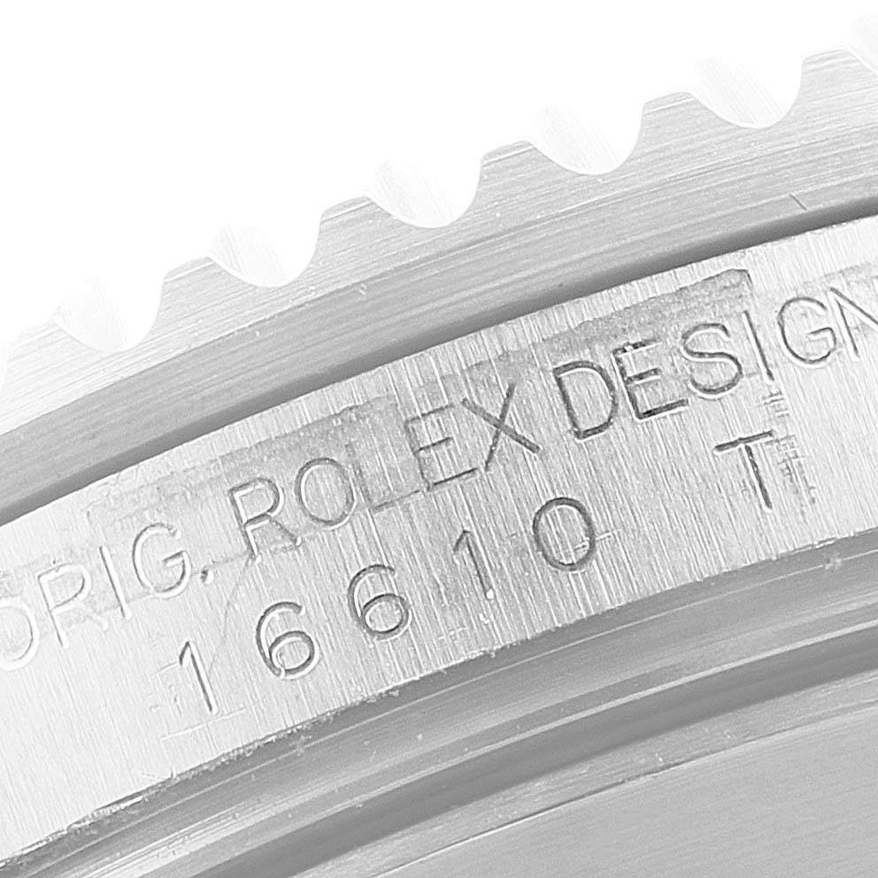 This close-up image shows the engraved side of the bezel of a Rolex Submariner 16610 Men
s Stainless Steel Black Dial 16610 Men
s Stainless Steel Black Dial model.