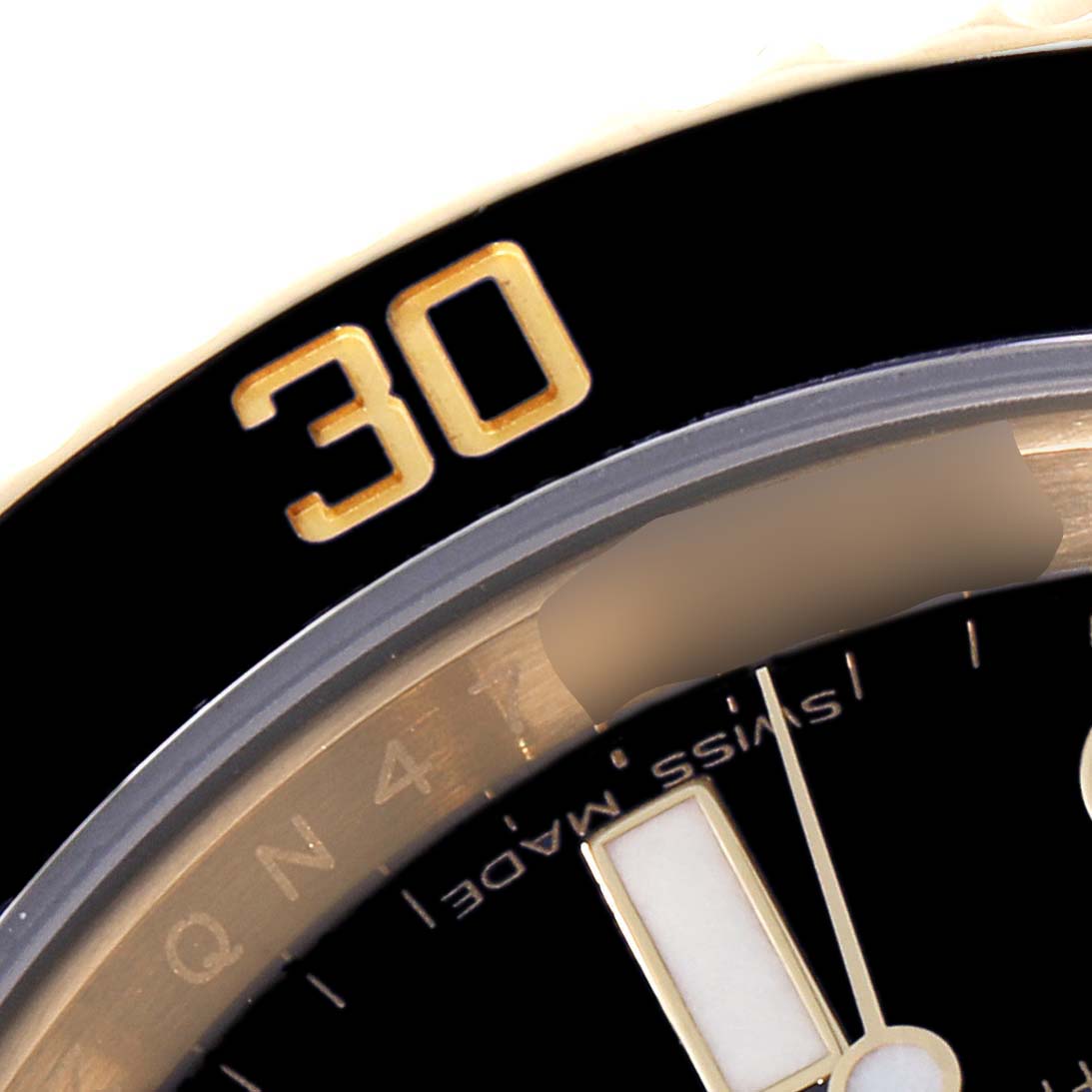 The image shows a close-up of the bezel and part of the dial of a Rolex Submariner 116618 Men's Yellow Gold Black Dial 116618 Men's Yellow Gold Black Dial.