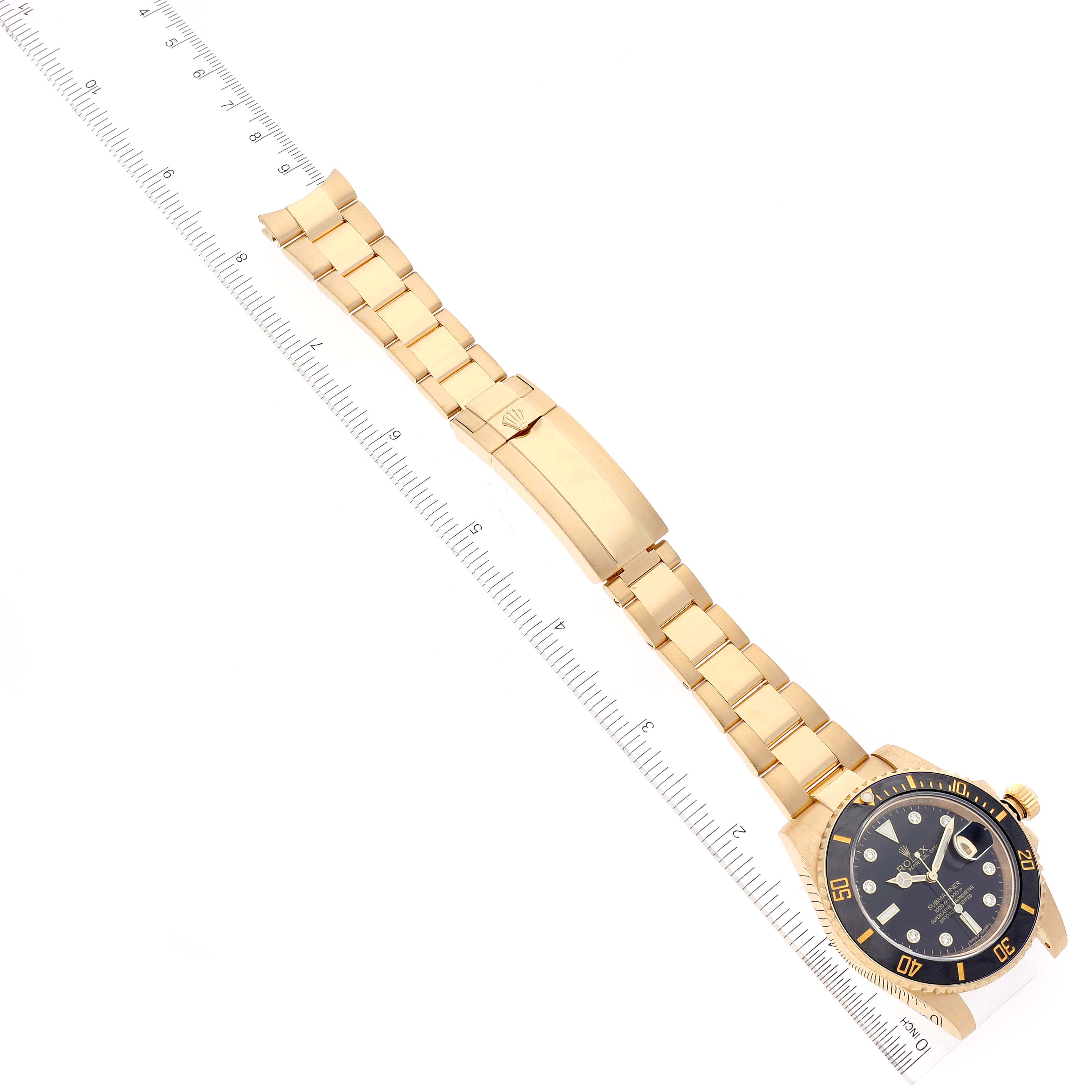 The Rolex Submariner 116618 Men's Yellow Gold Black Dial 116618 Men's Yellow Gold Black Dial is shown at an angle highlighting the full bracelet and clasp with a slight view of the face and bezel.
