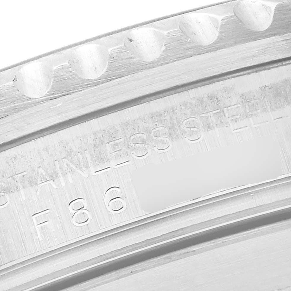 The image shows a close-up of the outer edge and engraved case back of the Rolex Submariner 16610 Men
s Stainless Steel Black Dial 16610 Men
s Stainless Steel Black Dial.