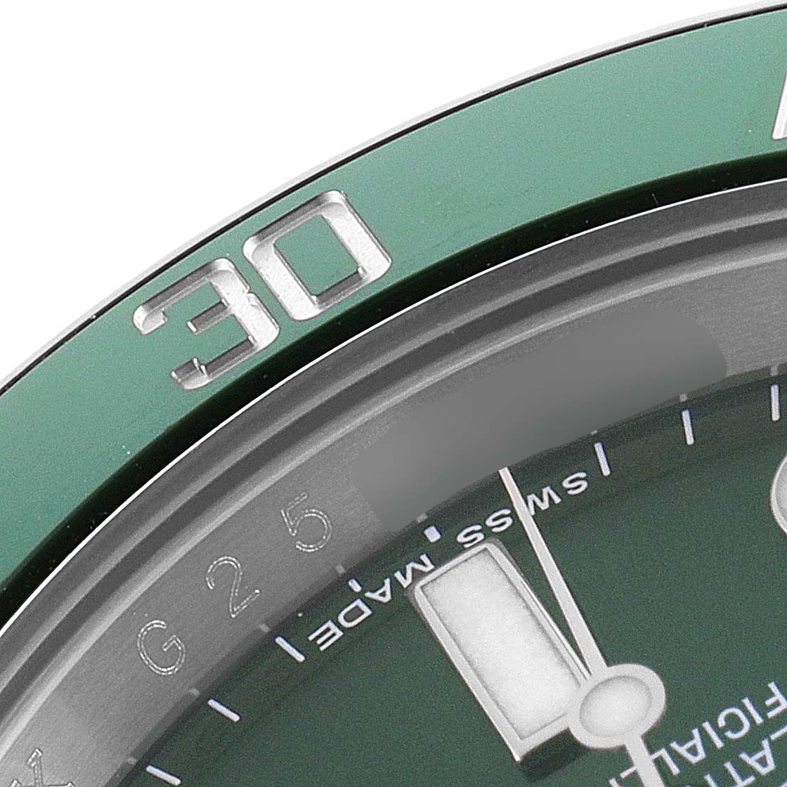 This close-up image shows the bezel and part of the dial of a Rolex Submariner 116610LV Men
s Stainless Steel Green Dial 116610LV Men
s Stainless Steel Green Dial watch with the "30" minute marker visible.