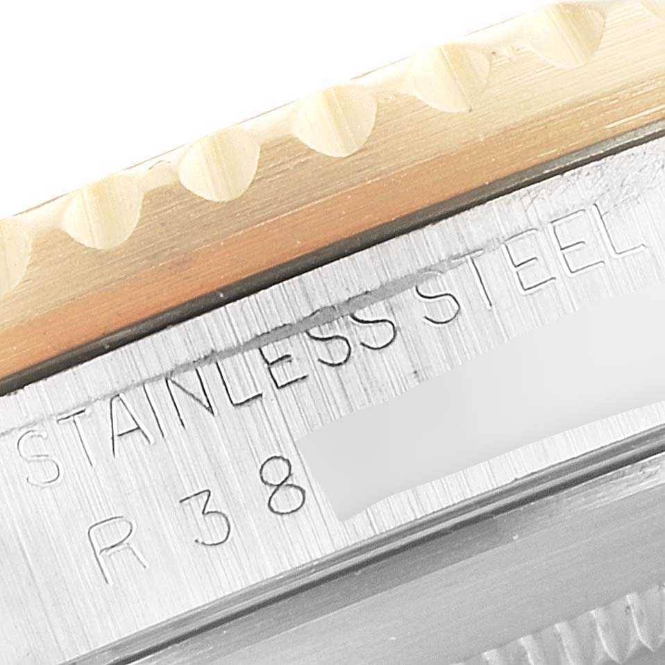 This image shows a close-up of the engraved case side of the Rolex Submariner 16803 Men's Steel and Gold (two tone) Black Dial 16803 Men's Steel and Gold (two tone) Black Dial, highlighting the stainless steel and reference number.