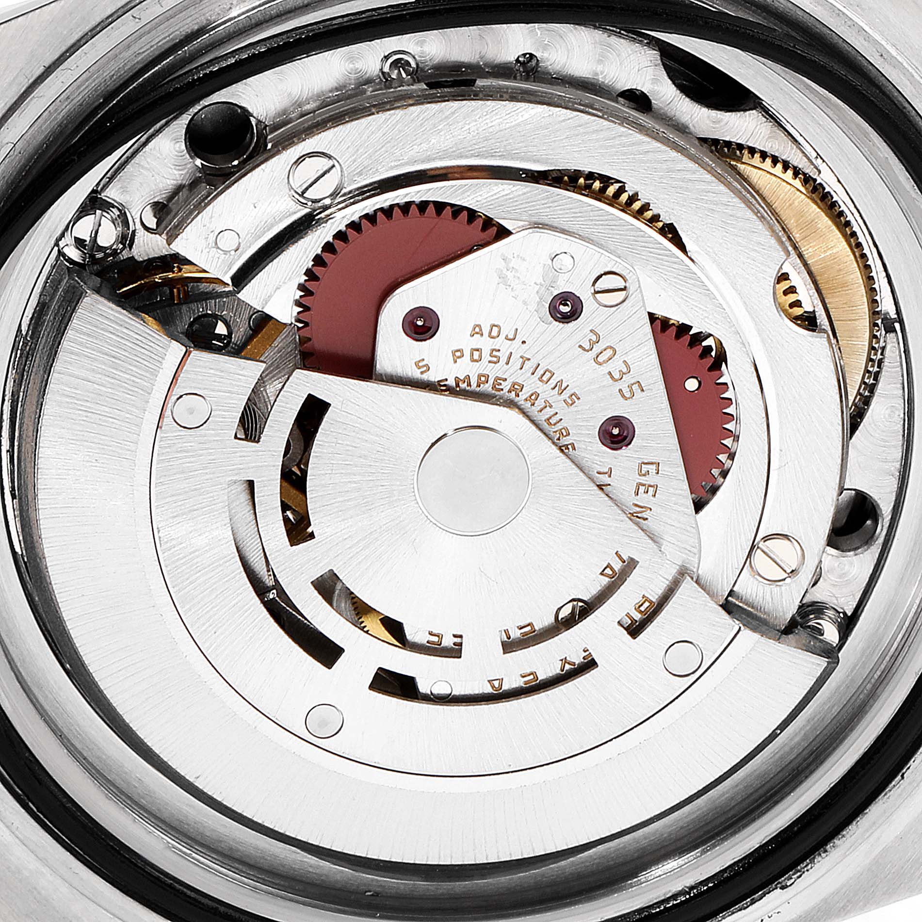 This image shows a close-up of the movement of a Rolex Submariner 16803 Men's Steel and Gold (two tone) Black Dial 16803 Men's Steel and Gold (two tone) Black Dial watch, focusing on its intricate gears and mechanical components.