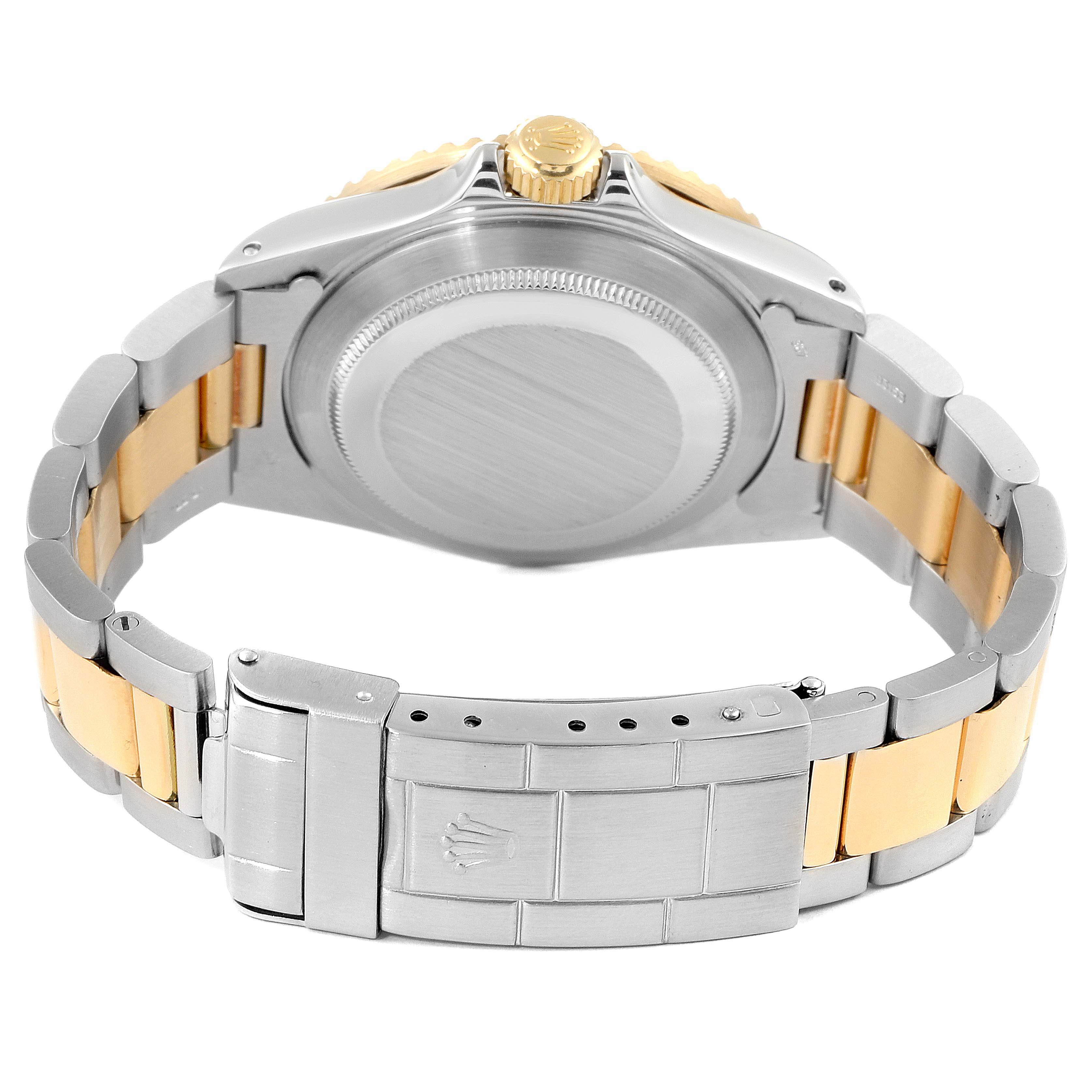 The image shows the back view of a Rolex Submariner 16803 Men's Steel and Gold (two tone) Black Dial 16803 Men's Steel and Gold (two tone) Black Dial watch, focusing on the clasp, bracelet, and case back.