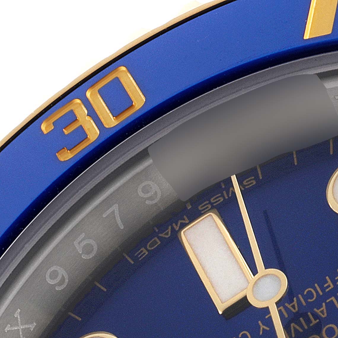 This close-up image shows the bezel, part of the dial, and the minute hand of a Rolex Submariner 116613 Men
s Steel and Gold (two tone) Blue Dial 116613 Men
s Steel and Gold (two tone) Blue Dial watch.