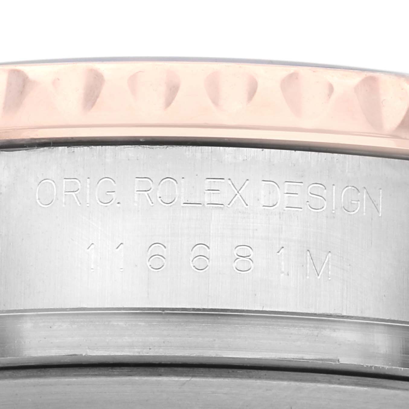 The image shows a close-up of the side of the Rolex Yacht-Master 116681 Men
s Steel and Gold (two tone) White Dial 116681 Men
s Steel and Gold (two tone) White Dial model, focusing on the engraved design and model number.