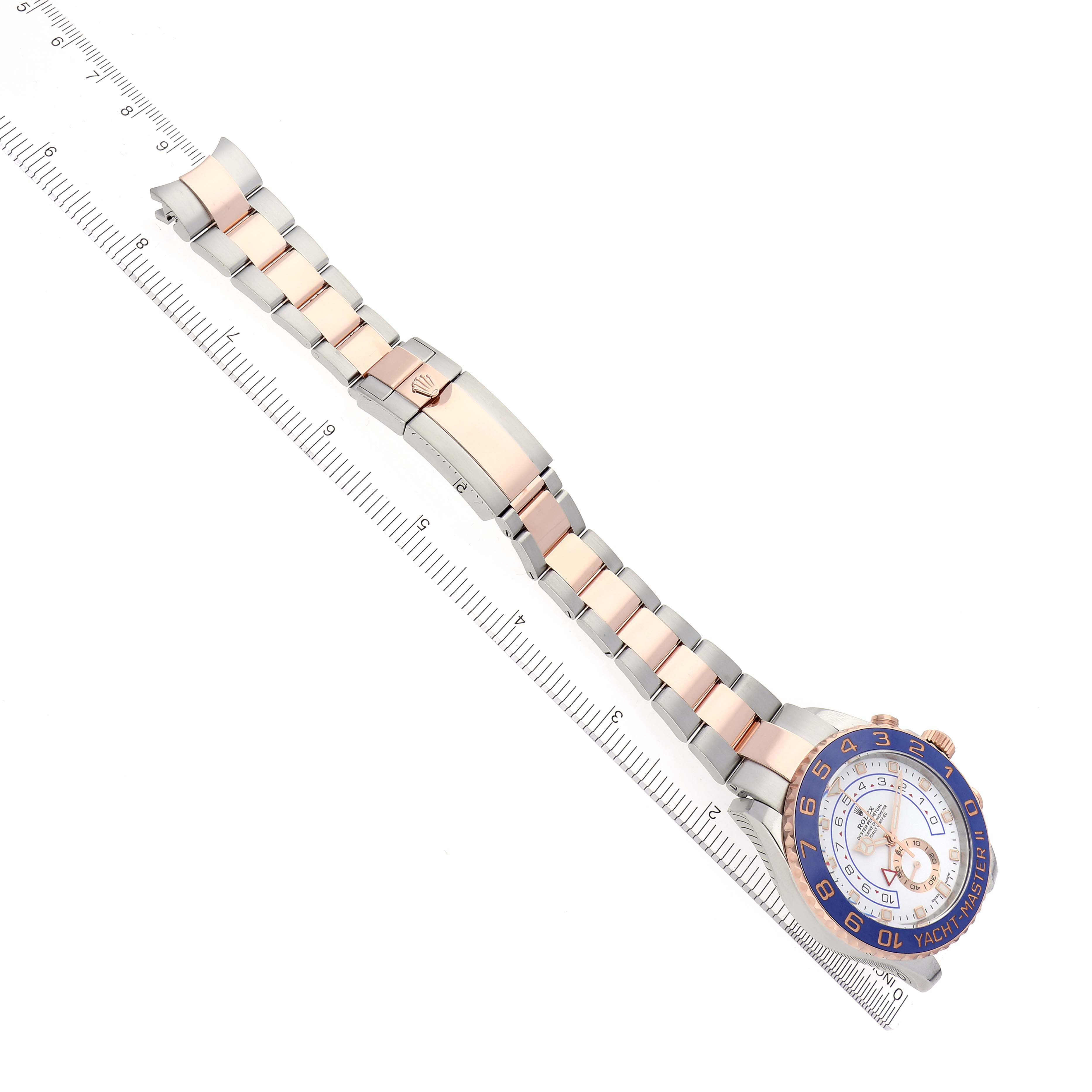 The Rolex Yacht-Master 116681 Men
s Steel and Gold (two tone) White Dial 116681 Men
s Steel and Gold (two tone) White Dial watch is shown from a top view, displaying the bracelet, clasp, and face.