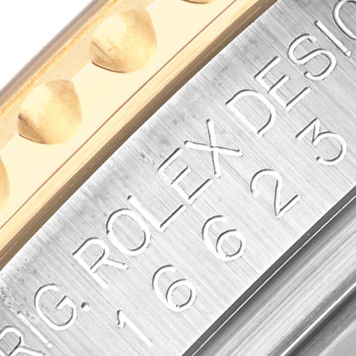 The image shows a close-up of the engraved bezel edge and side of a Rolex Yacht-Master 16623 Men's Steel and Gold (two tone) White Dial 16623 Men's Steel and Gold (two tone) White Dial watch, highlighting its texture and detailing.