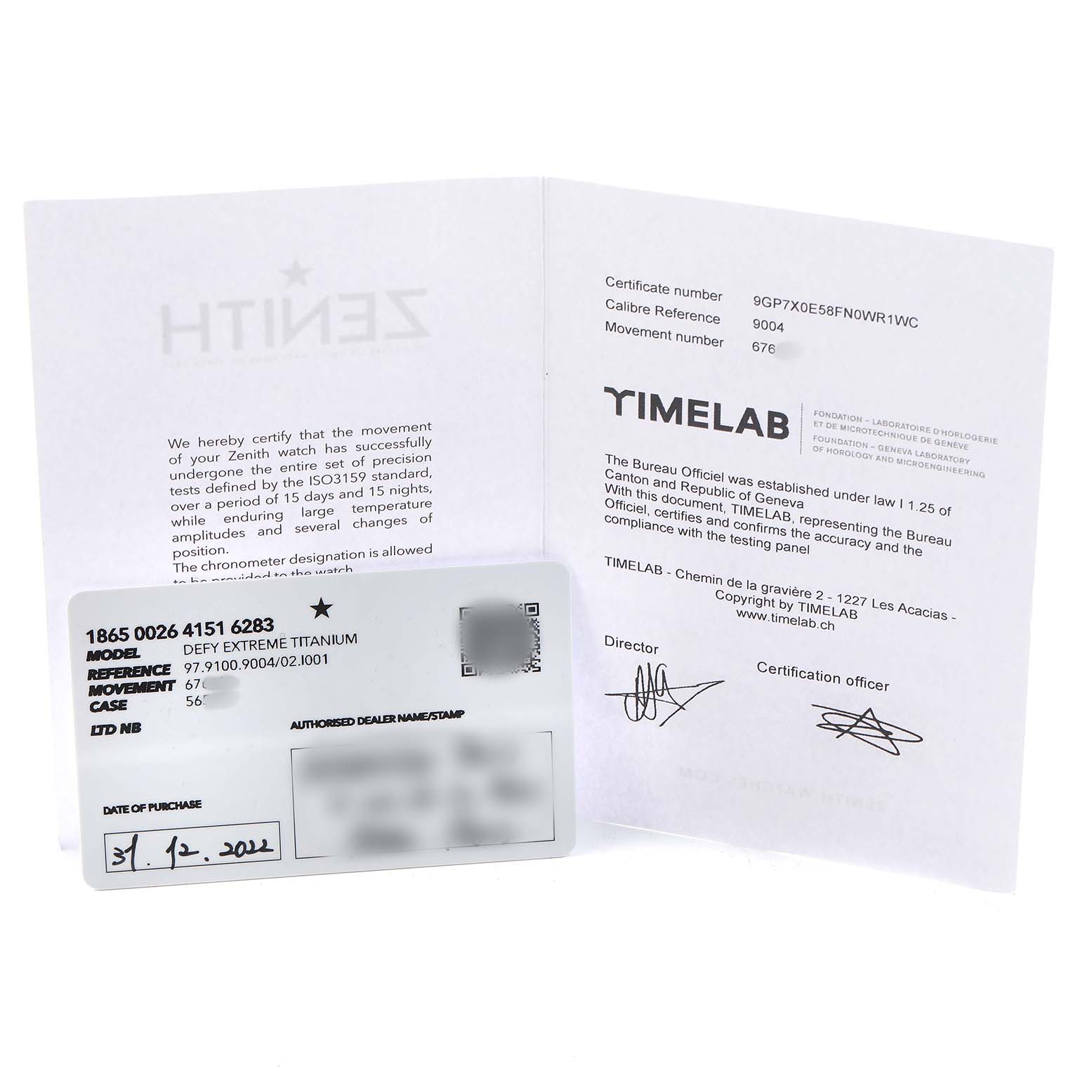 The image shows documentation and certification for the Zenith Defy 97.9100.9004/02.I001 Men's Titanium Grey Dial model, including a card detailing model and movement specifics.