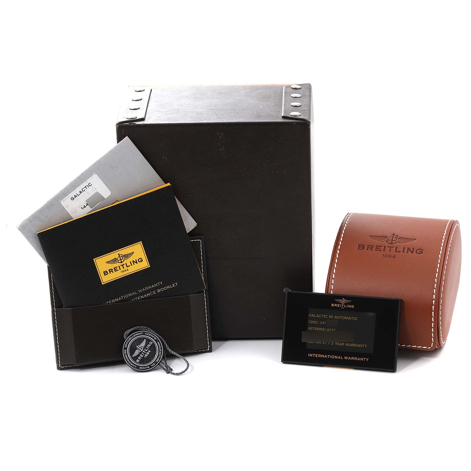 The image shows accessories for the Breitling Galactic A3733053/A717 Men's Stainless Steel Mother of Pearl Dial A3733053/A717 Men's Stainless Steel Mother of Pearl Dial watch, including boxes, manuals, and a warranty card.
