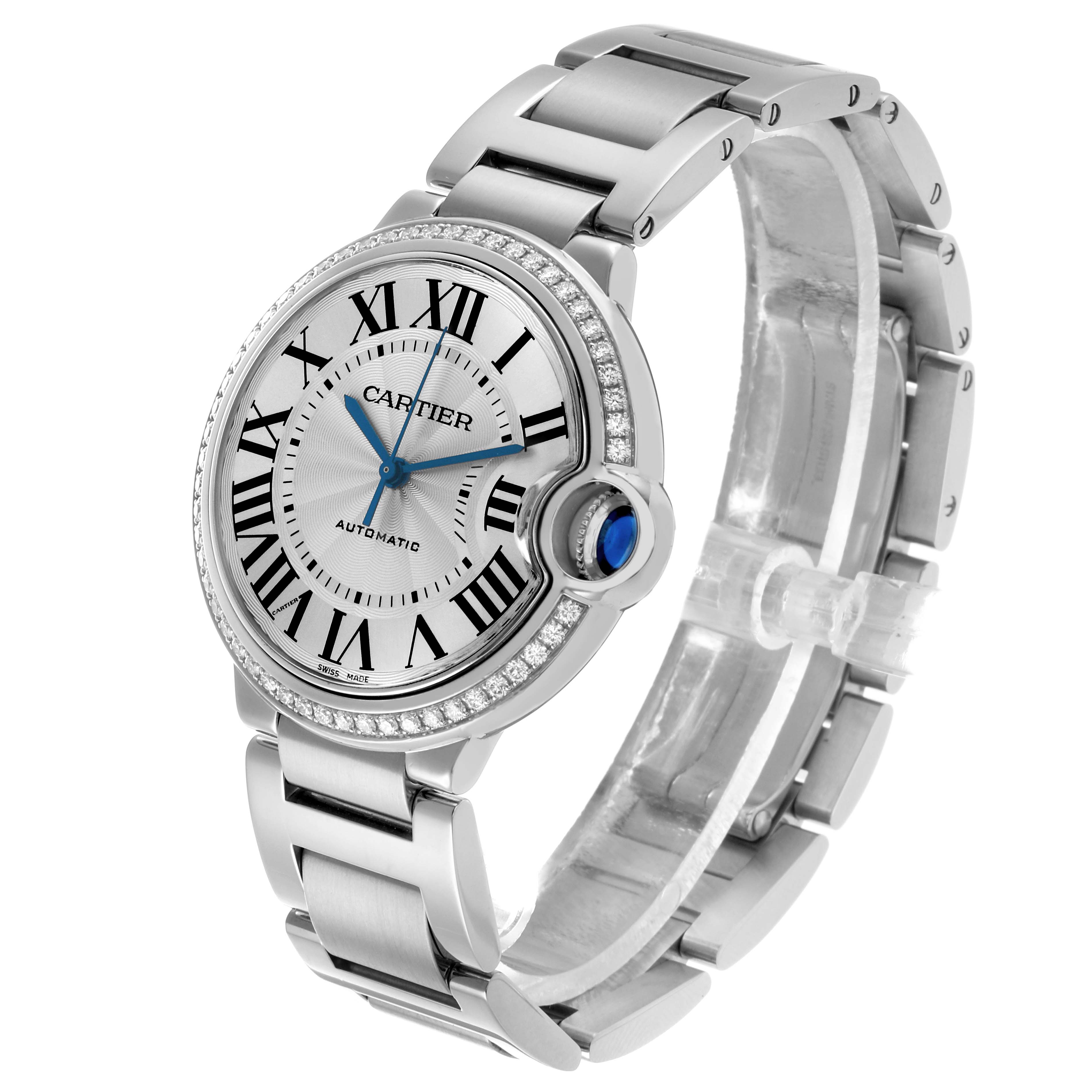 The Ballon Bleu de Cartier watch is shown at a three-quarter angle, highlighting its face, crown, and bracelet.