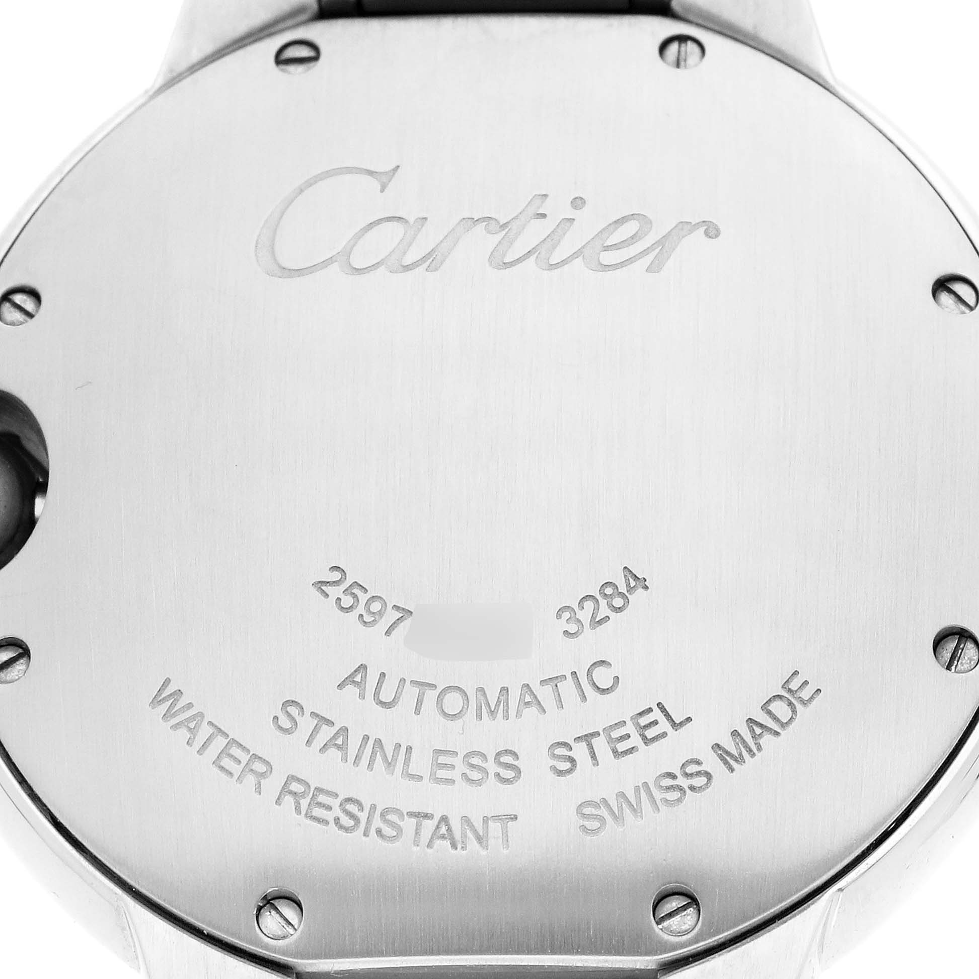 The image shows the back case of the Ballon Bleu by Cartier, featuring engravings and screws.