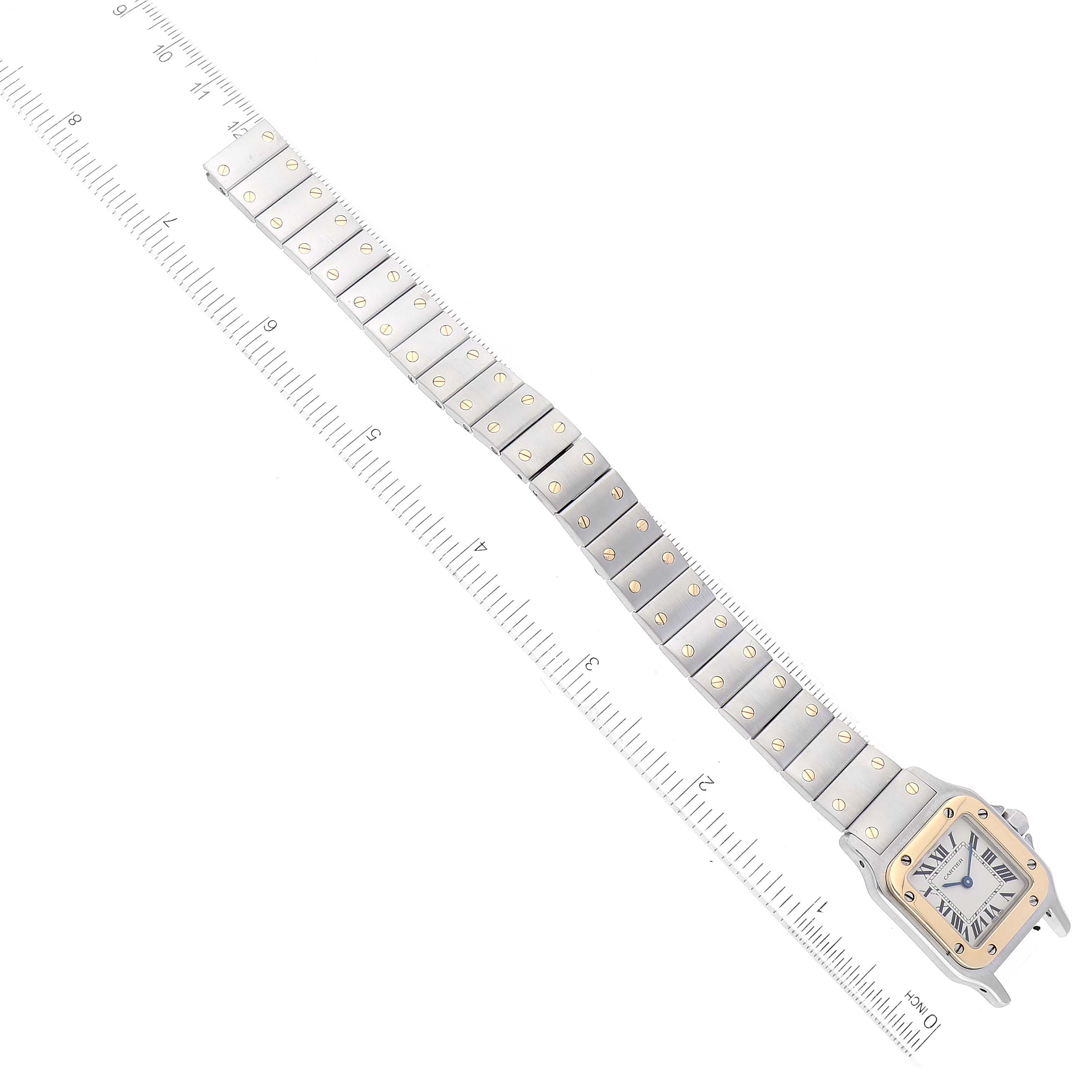 The image shows a Cartier Santos W20012C4 Women's Steel and Gold (two tone) Silver Dial W20012C4 Women's Steel and Gold (two tone) Silver Dial watch with a full view of the face and bracelet, set against a ruler for size reference.