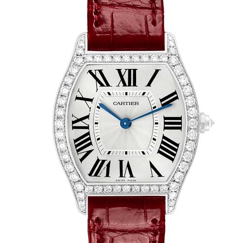 The Cartier Tortue WA501009 Women's White Gold Silver Dial watch is shown from the front, highlighting its dial, Roman numerals, diamond bezel, and red strap.