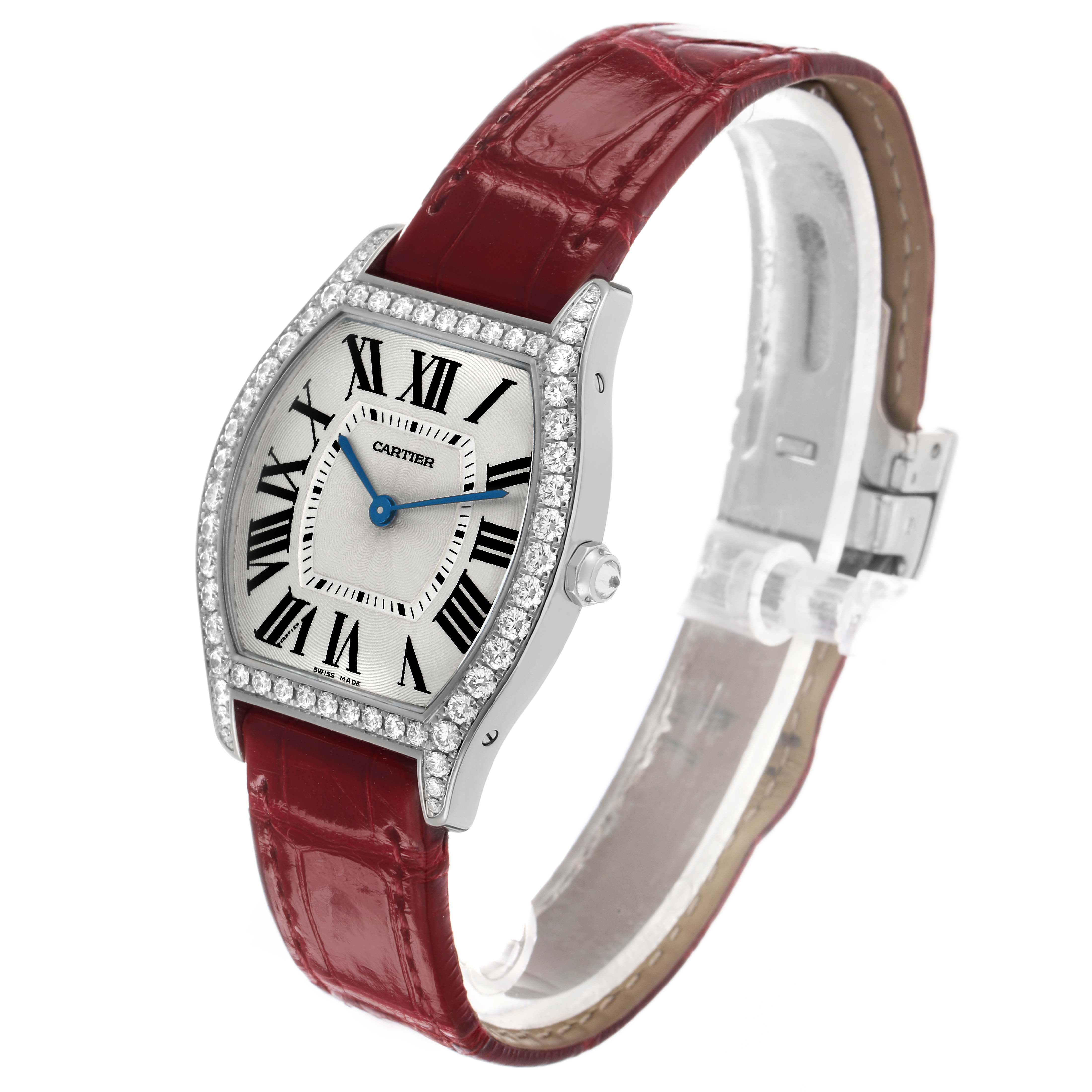 The Cartier Tortue WA501009 Women's White Gold Silver Dial watch is shown at a three-quarter angle, displaying the face, case, crown, and red leather strap.