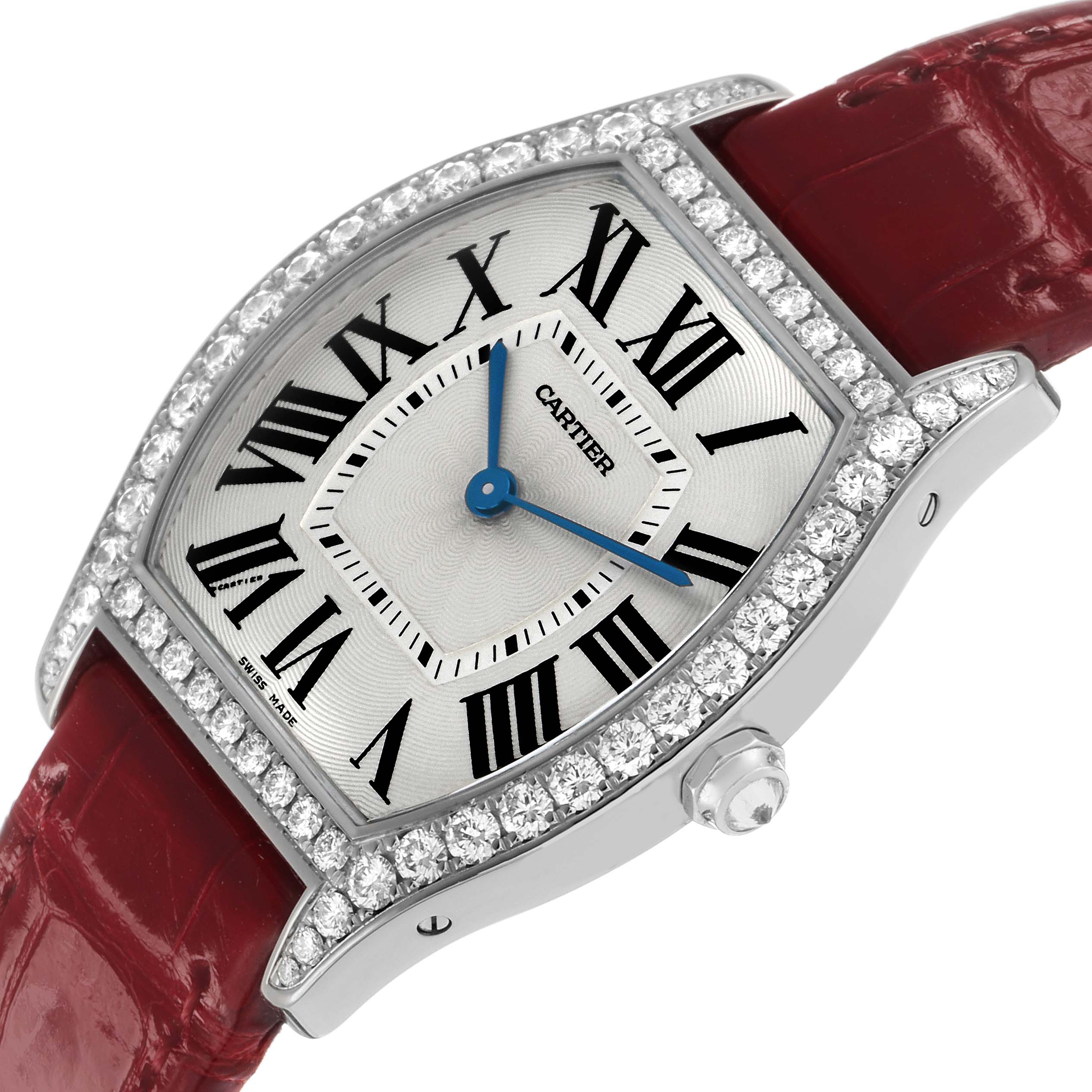 The Cartier Tortue WA501009 Women's White Gold Silver Dial watch is shown at an angled view, highlighting the diamond bezel, Roman numerals, and red leather strap.