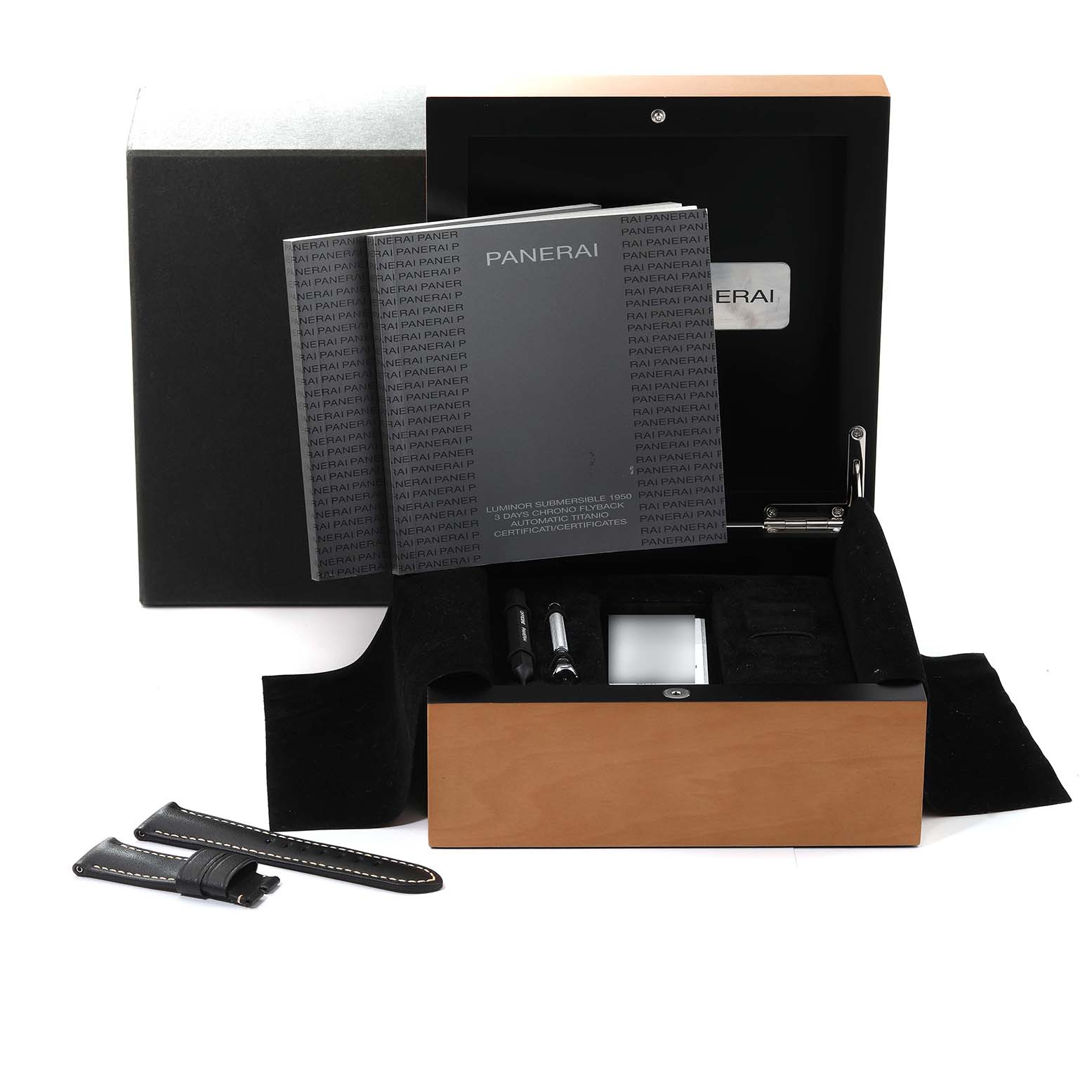 The image shows an open box of Panerai Submersible PAM00615 Men's Titanium Black Dial PAM00615 Men's Titanium Black Dial watch accessories, including booklets, tools, and an extra strap, from a front angle.