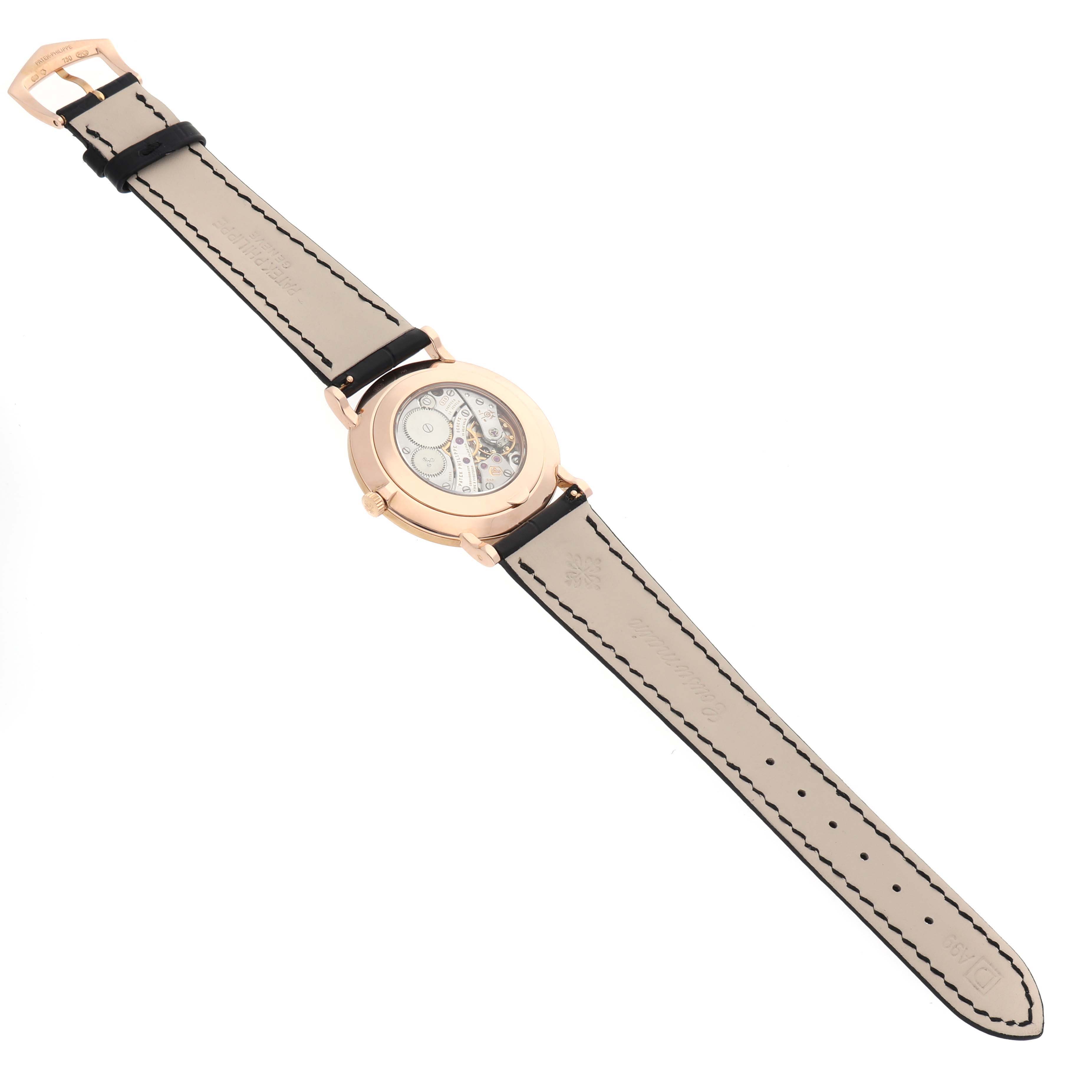 The Patek Philippe Calatrava 5119R-001 Men's Rose Gold White Dial watch is shown from the back, highlighting its movement and leather strap.