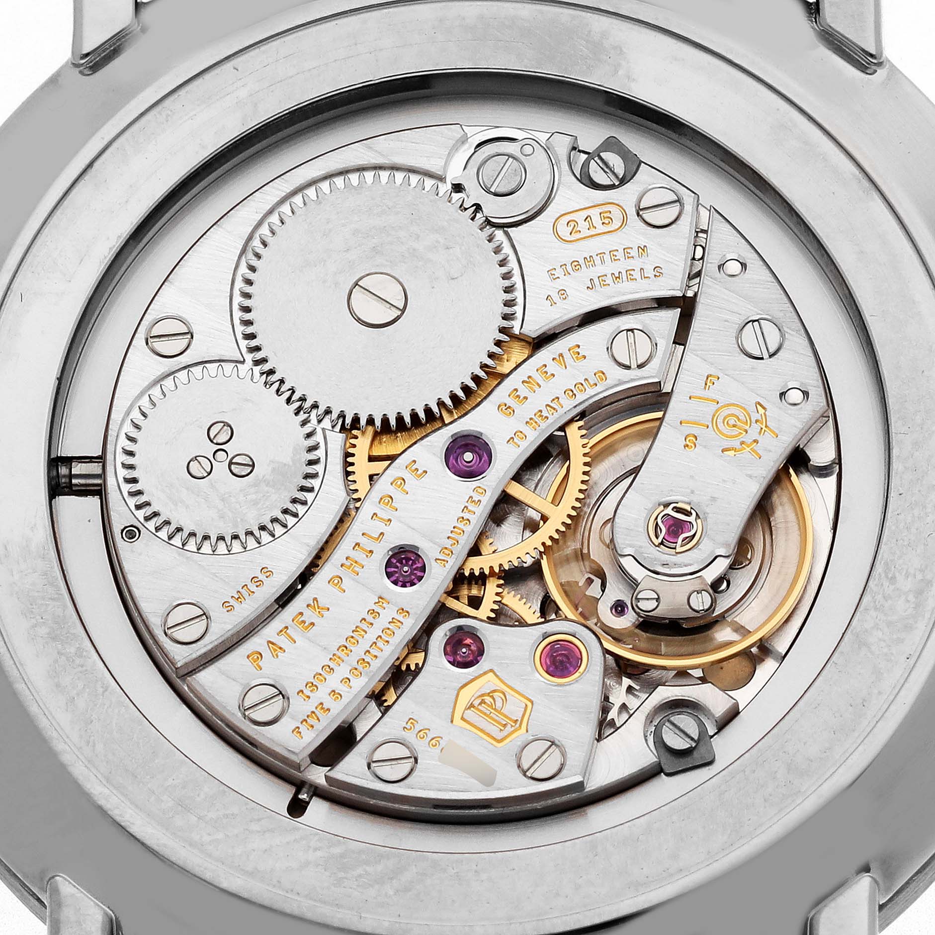 The image shows the intricate movement of a Patek Philippe Calatrava 5119G-001 Men's White Gold White Dial model viewed from the back, highlighting gears and jewels.