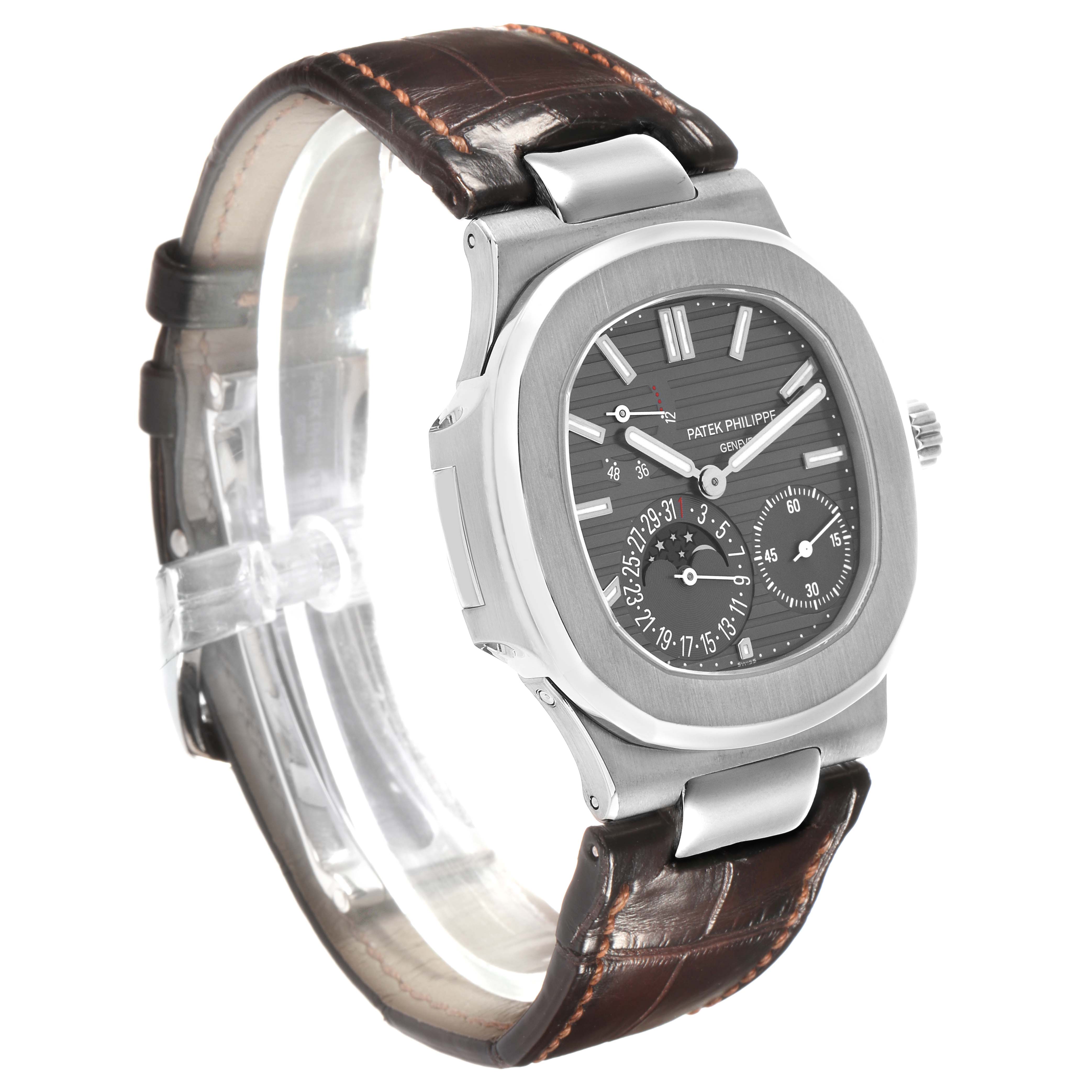 The image shows a Patek Philippe Nautilus 5712G-001 Men's White Gold Grey Dial watch at a 3/4 angle, highlighting its watch face, bezel, and leather strap.