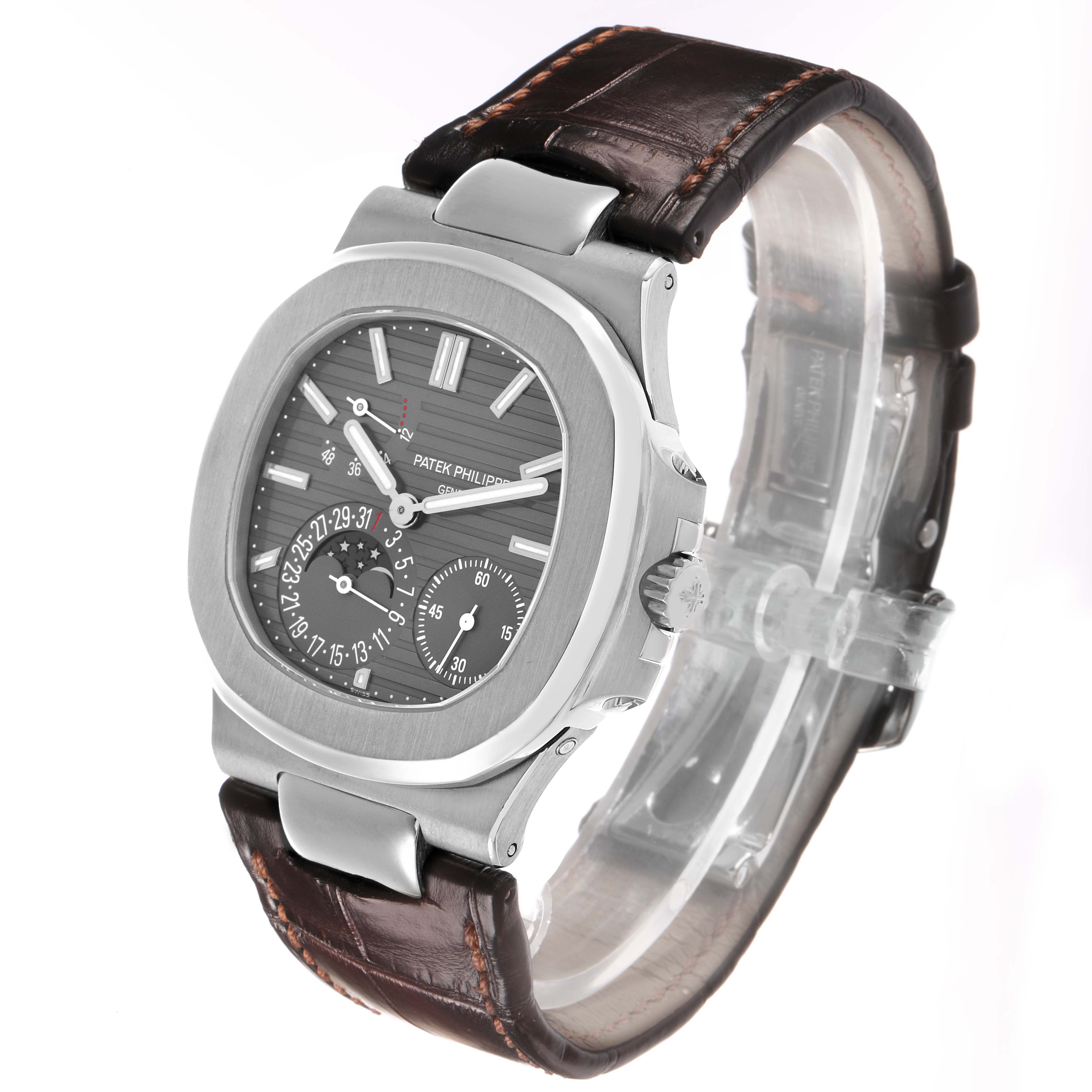 The Patek Philippe Nautilus 5712G-001 Men's White Gold Grey Dial watch is angled to show the face and crown, highlighting its brown leather strap and detailed dial.
