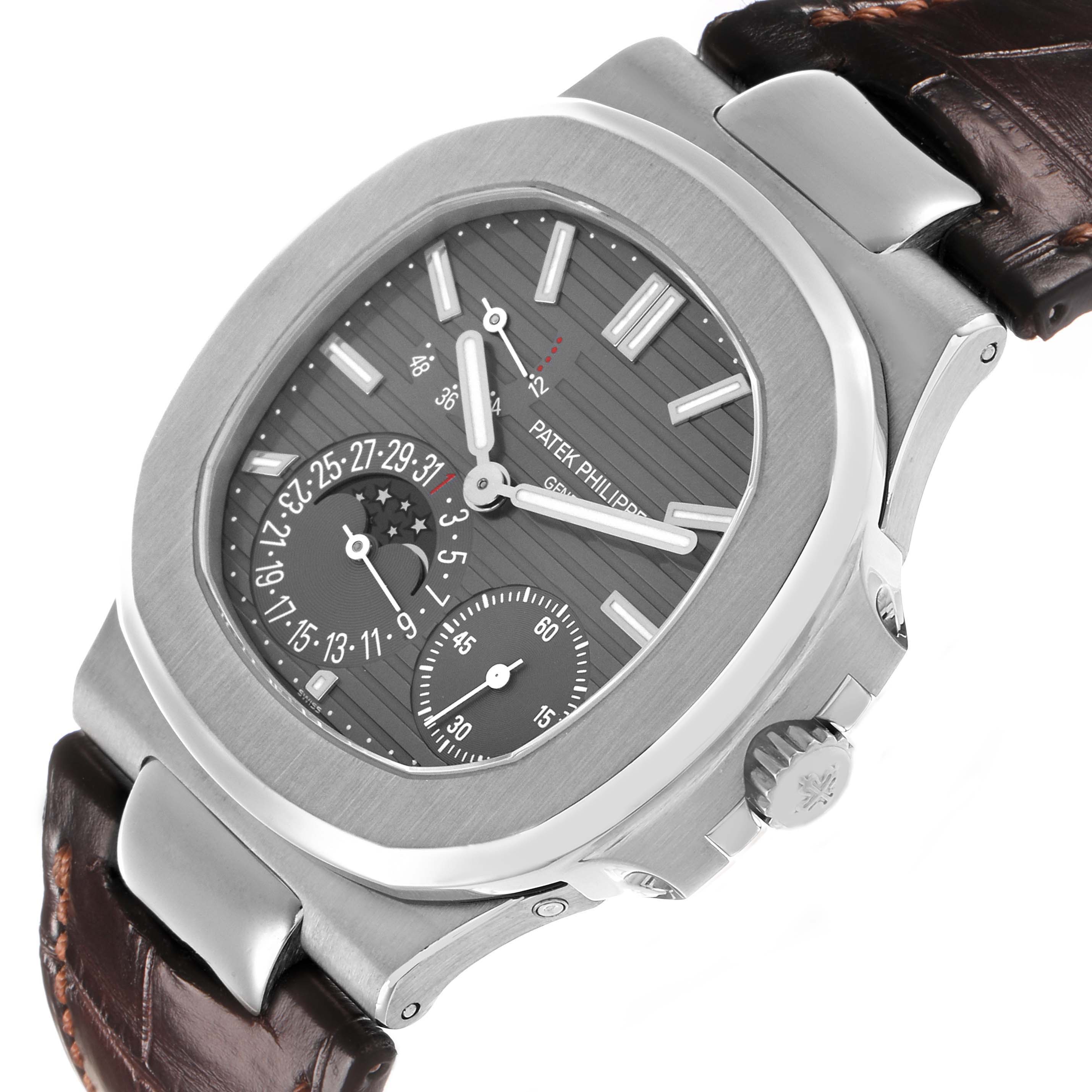 The Patek Philippe Nautilus 5712G-001 Men's White Gold Grey Dial watch is shown at a slight angle, highlighting the dial, subdials, bezel, and part of the leather strap.